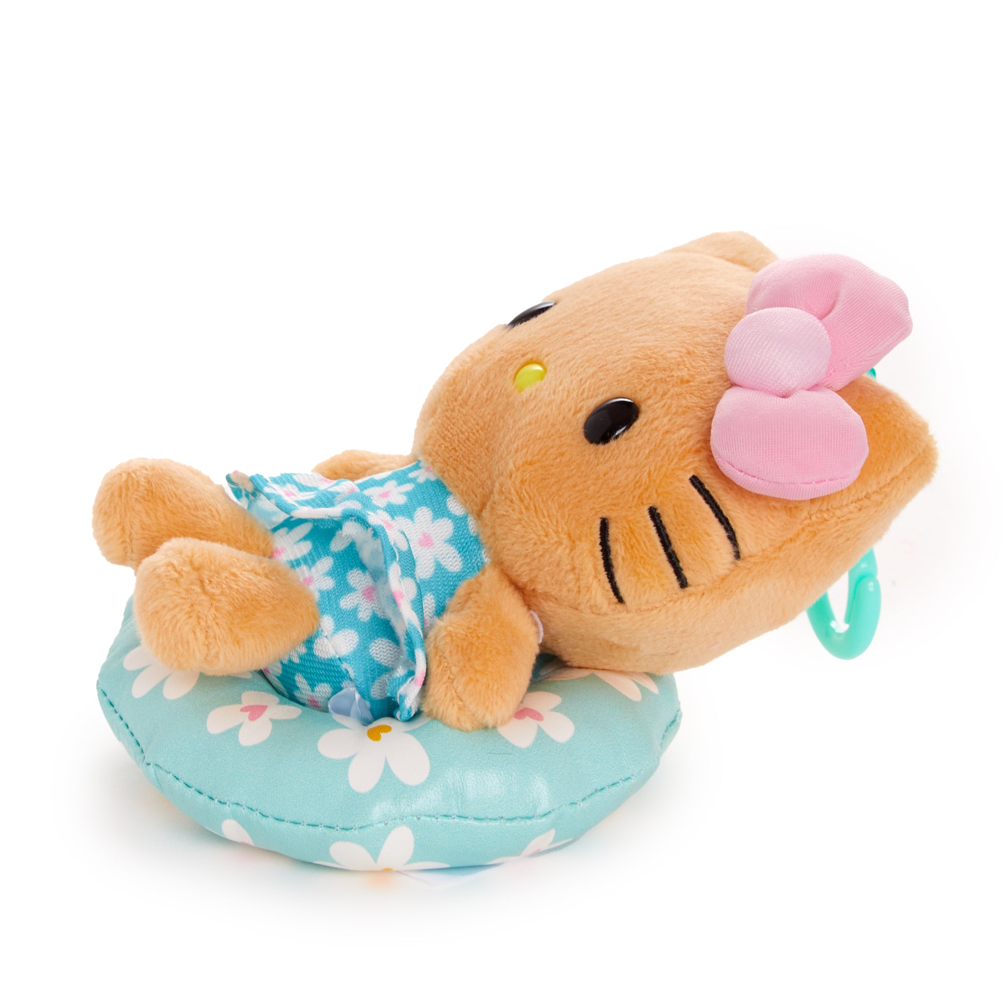 Mocha Sanrio plush on a beach towel with floral summer props
