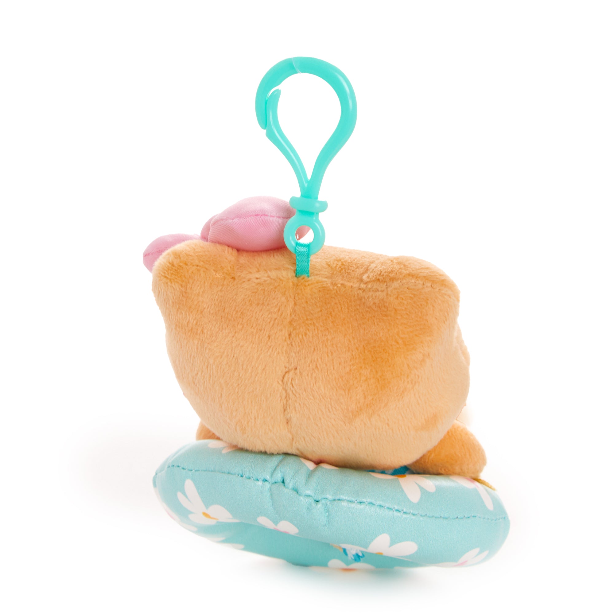 Mocha Sanrio plush on a beach towel with floral summer props