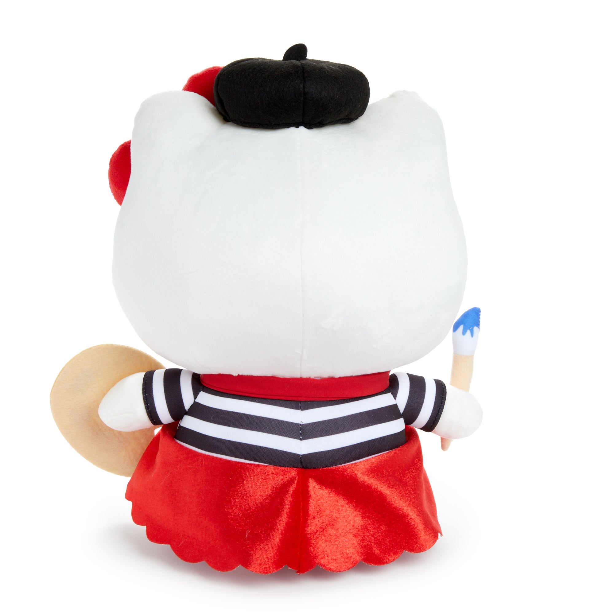 Hello Kitty art plush doll on a desk with craft supplies