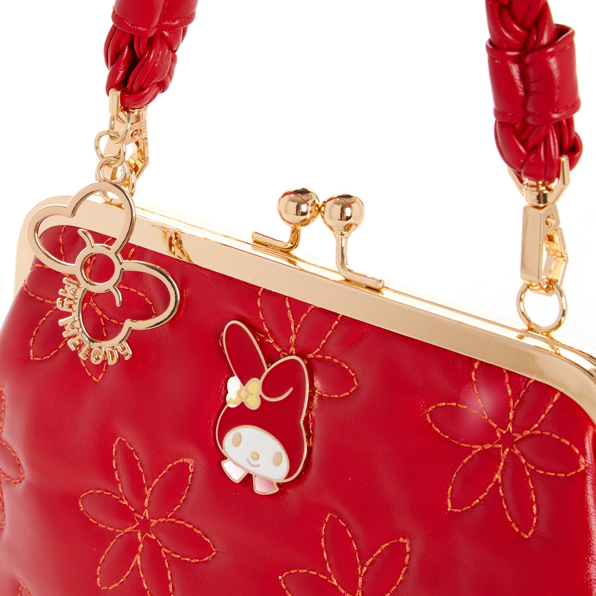 Side angle of vintage handbag showing braided shoulder strap and gold hardware