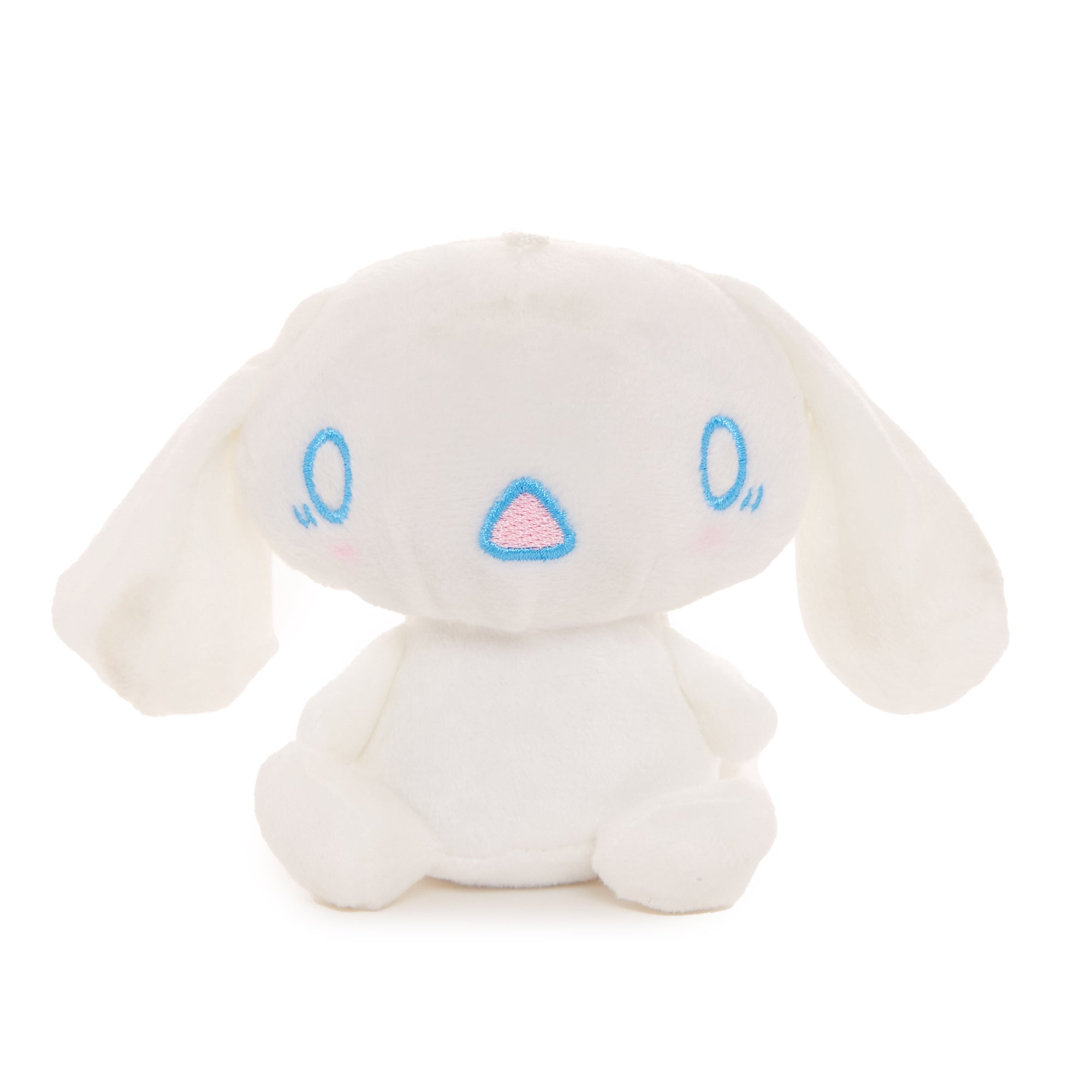 Cinnamoroll plush mascot keychain with removable cape hanging on a backpack