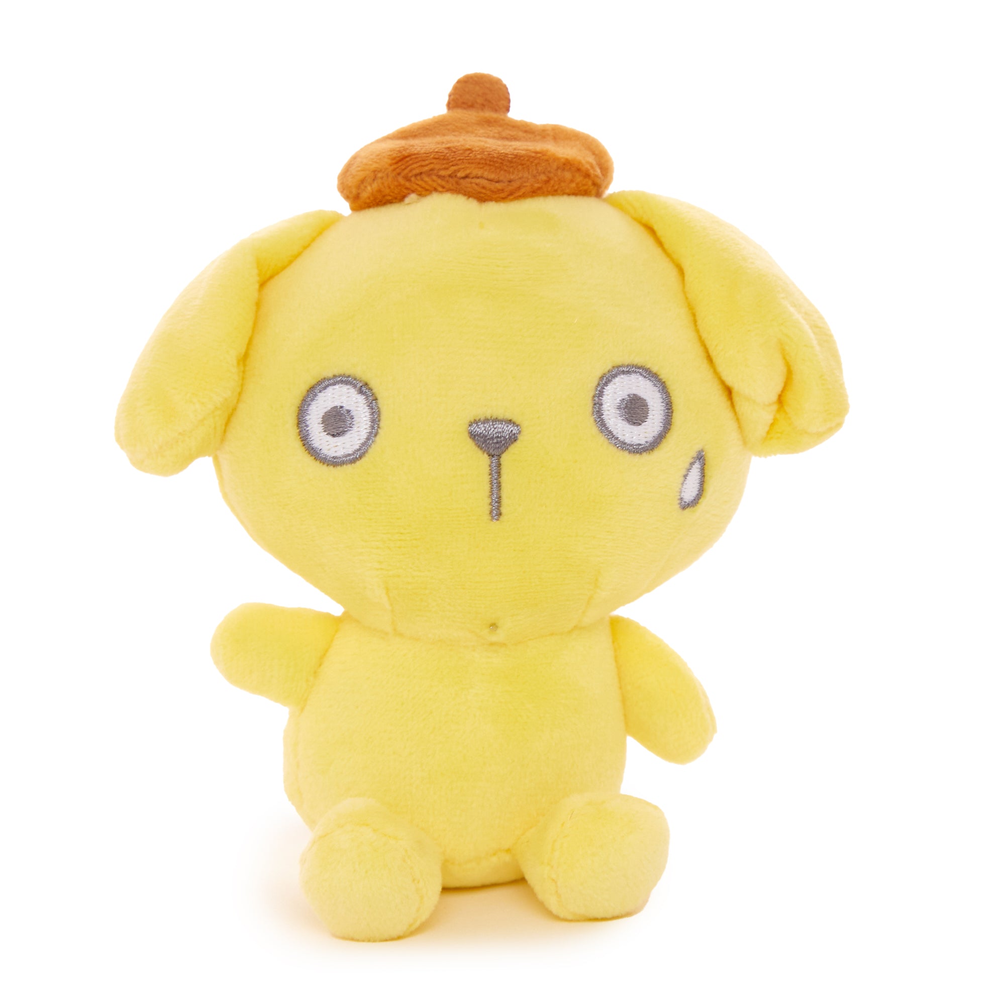 Back angle of Hello Kitty plush keychain alongside other Pompompurin merchandise on desk