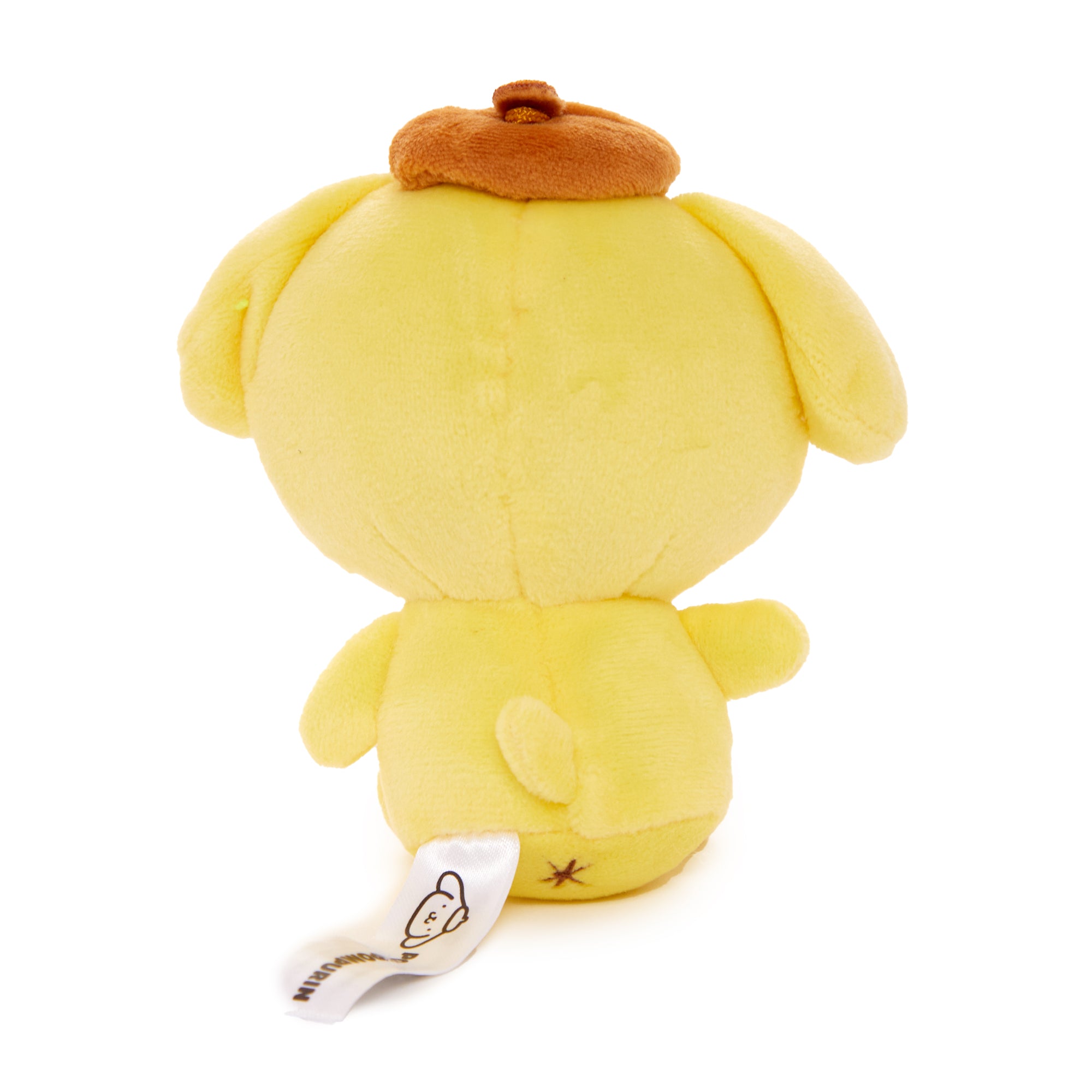 Back angle of Hello Kitty plush keychain alongside other Pompompurin merchandise on desk