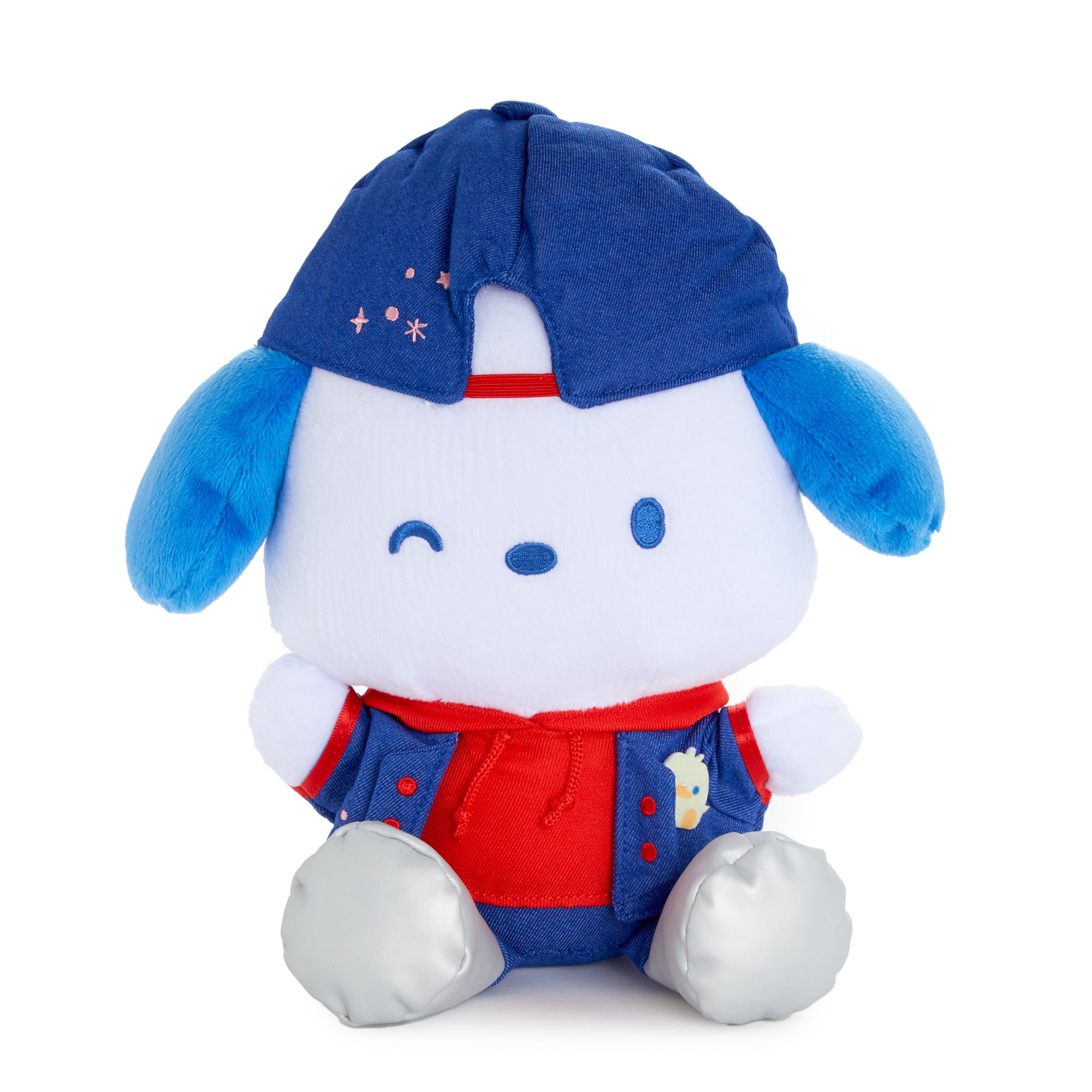 Pochacco plush toy sitting on a shelf with other Sanrio collectibles