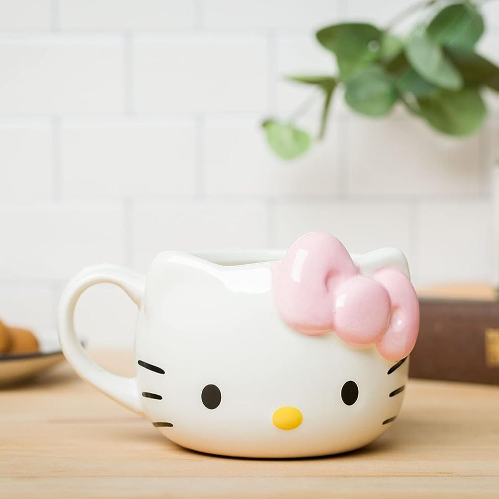 Hello Kitty mug on a wooden table with coffee inside