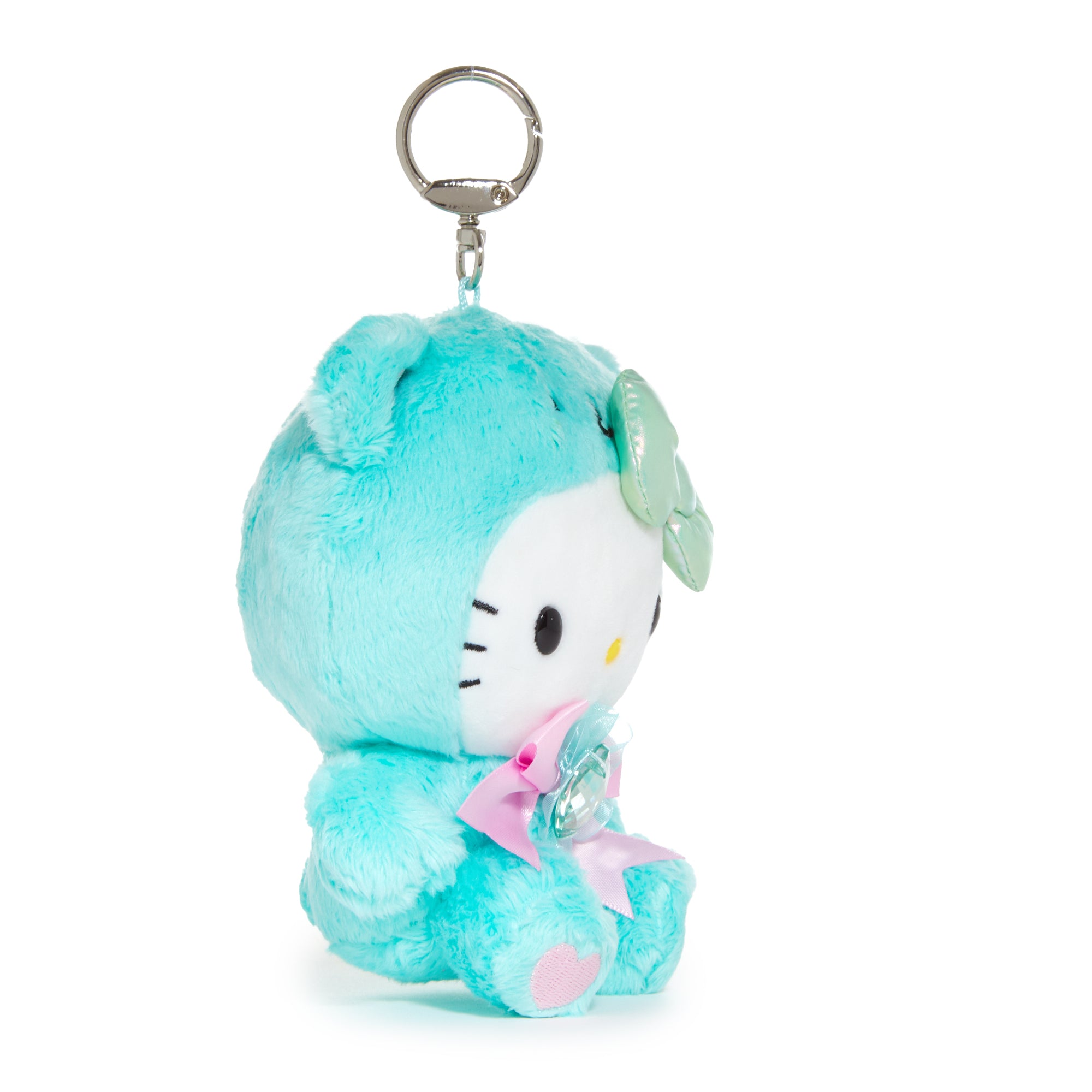 Hello Kitty plush keychain with emerald birthstone dangling from a backpack zipper