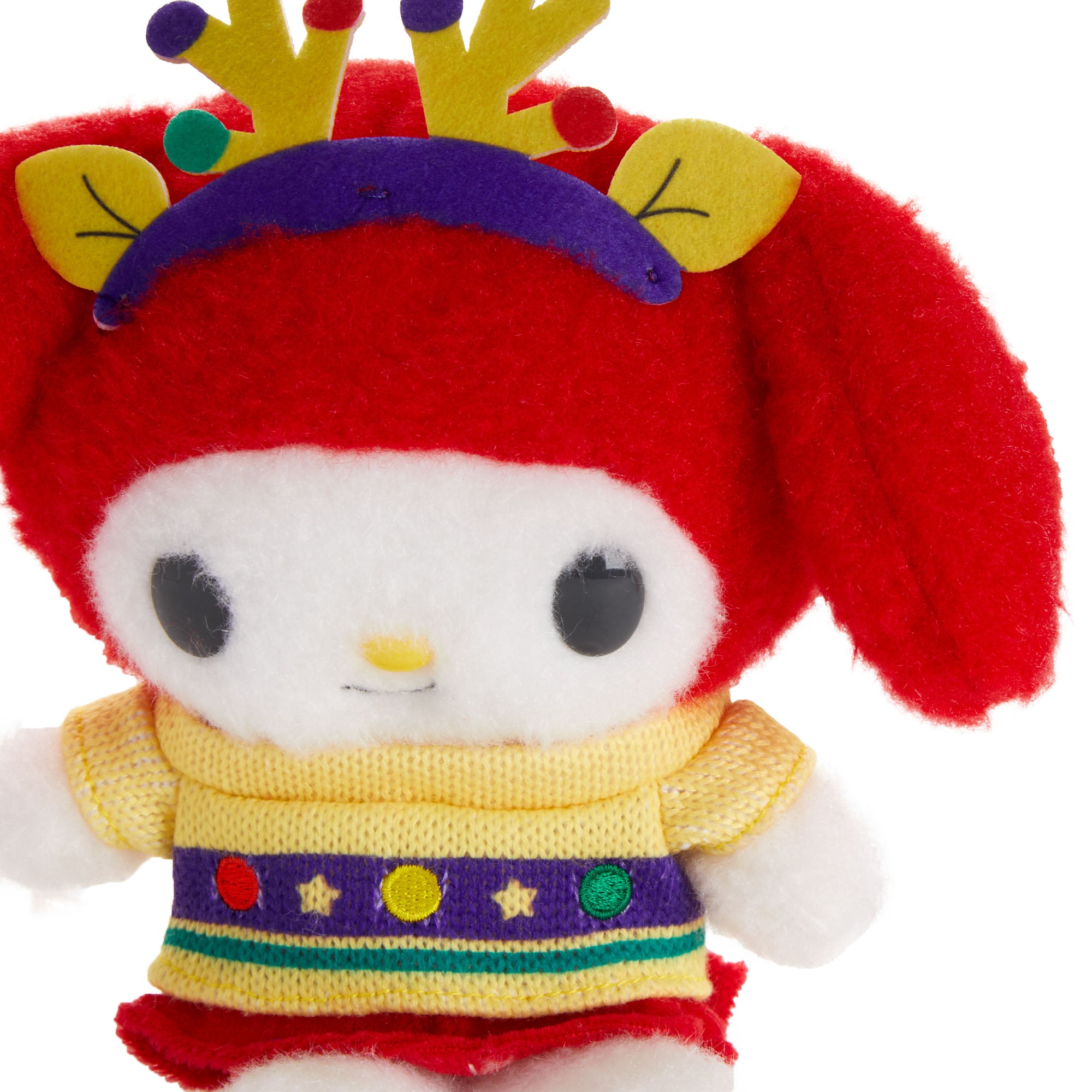 My Melody plush toy in a holiday sweater, posed with other Sanrio characters in a festive holiday setting