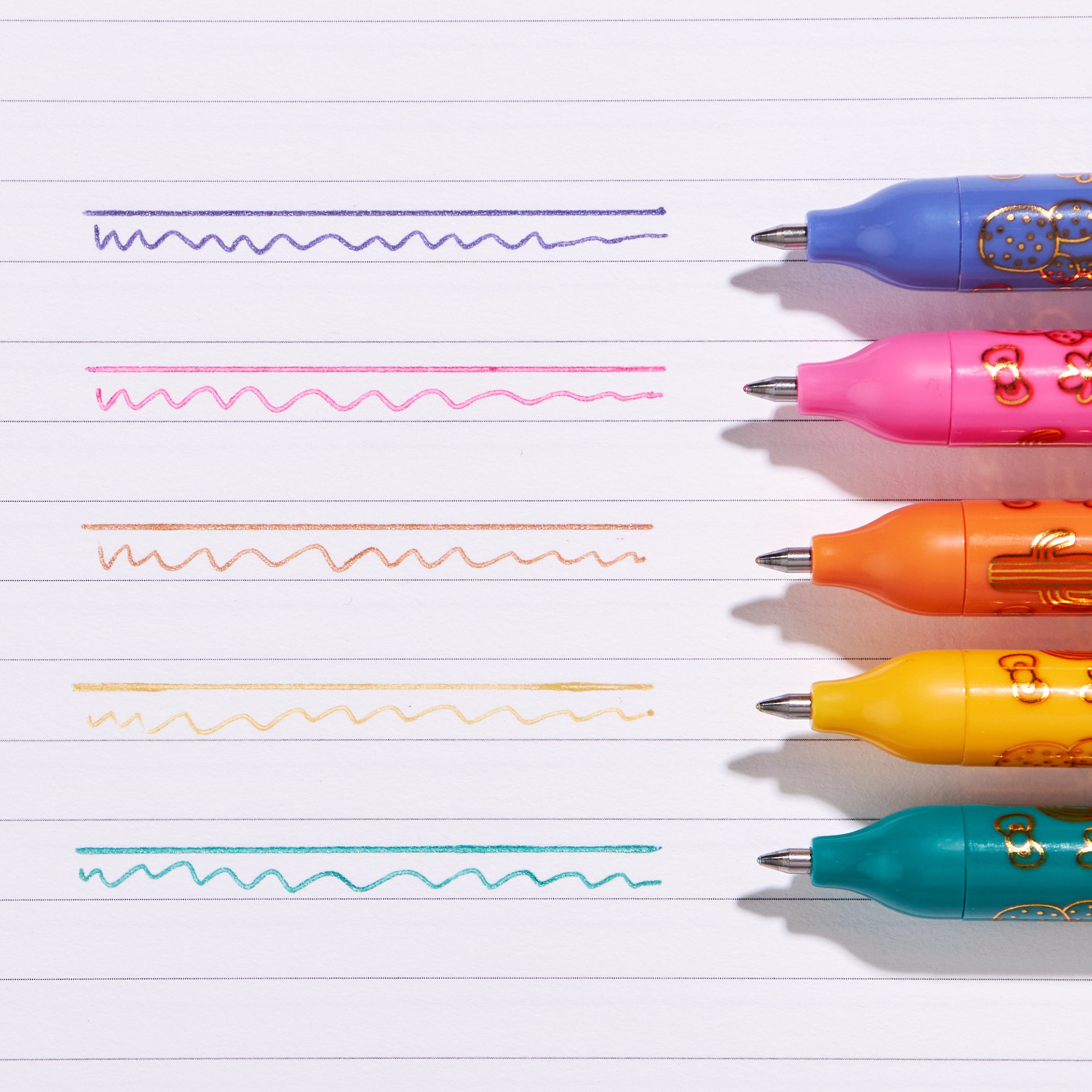 Hello Kitty x Erin Condren metallic gel pens in vibrant colors on a creative workspace