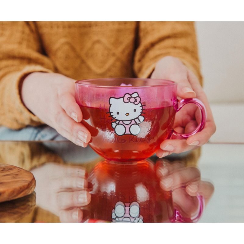 Close-up of the base and handle of the cute coffee mug with warm tea beside a journal.