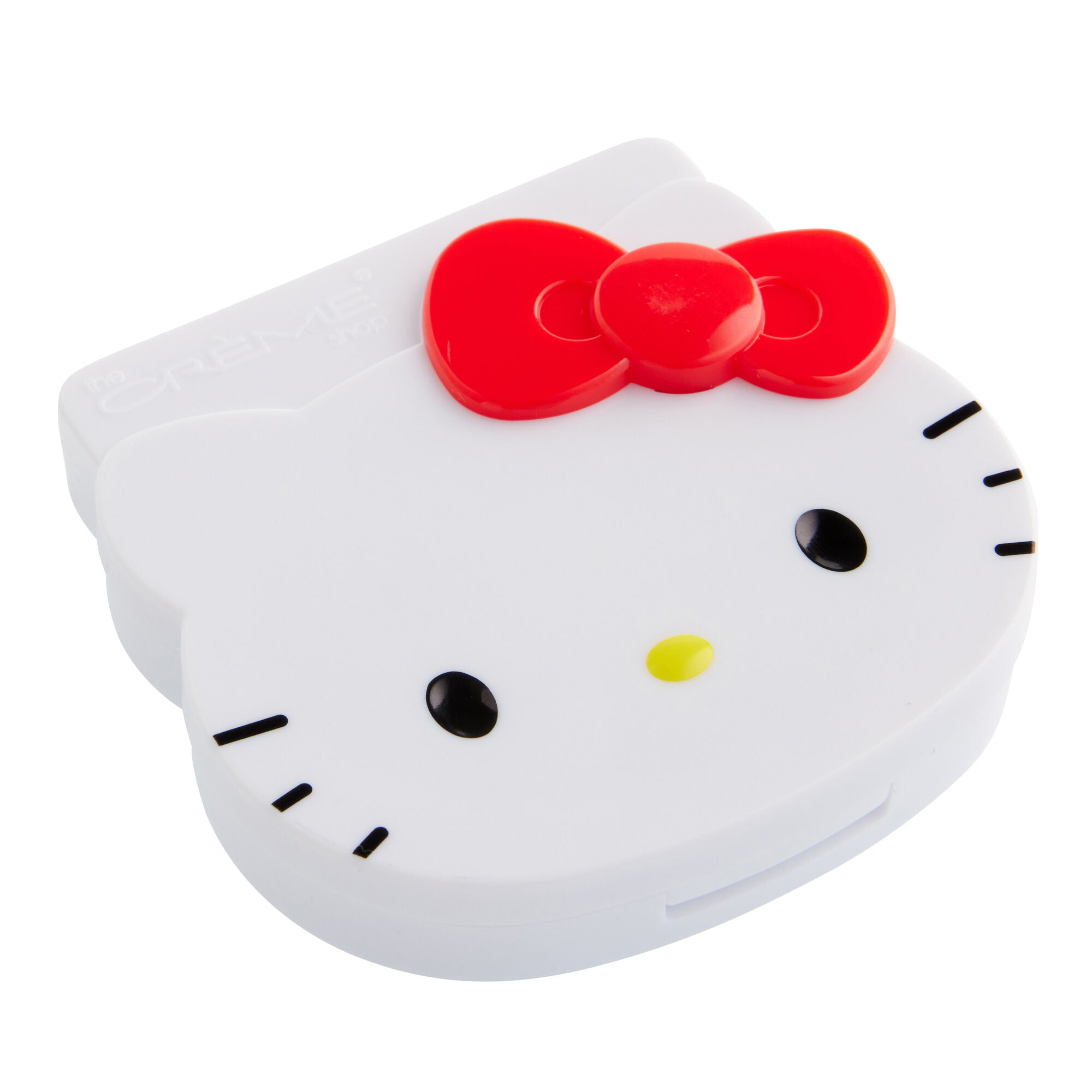 Front view of the creme hello kitty blotting paper mirrored compact on a vanity table