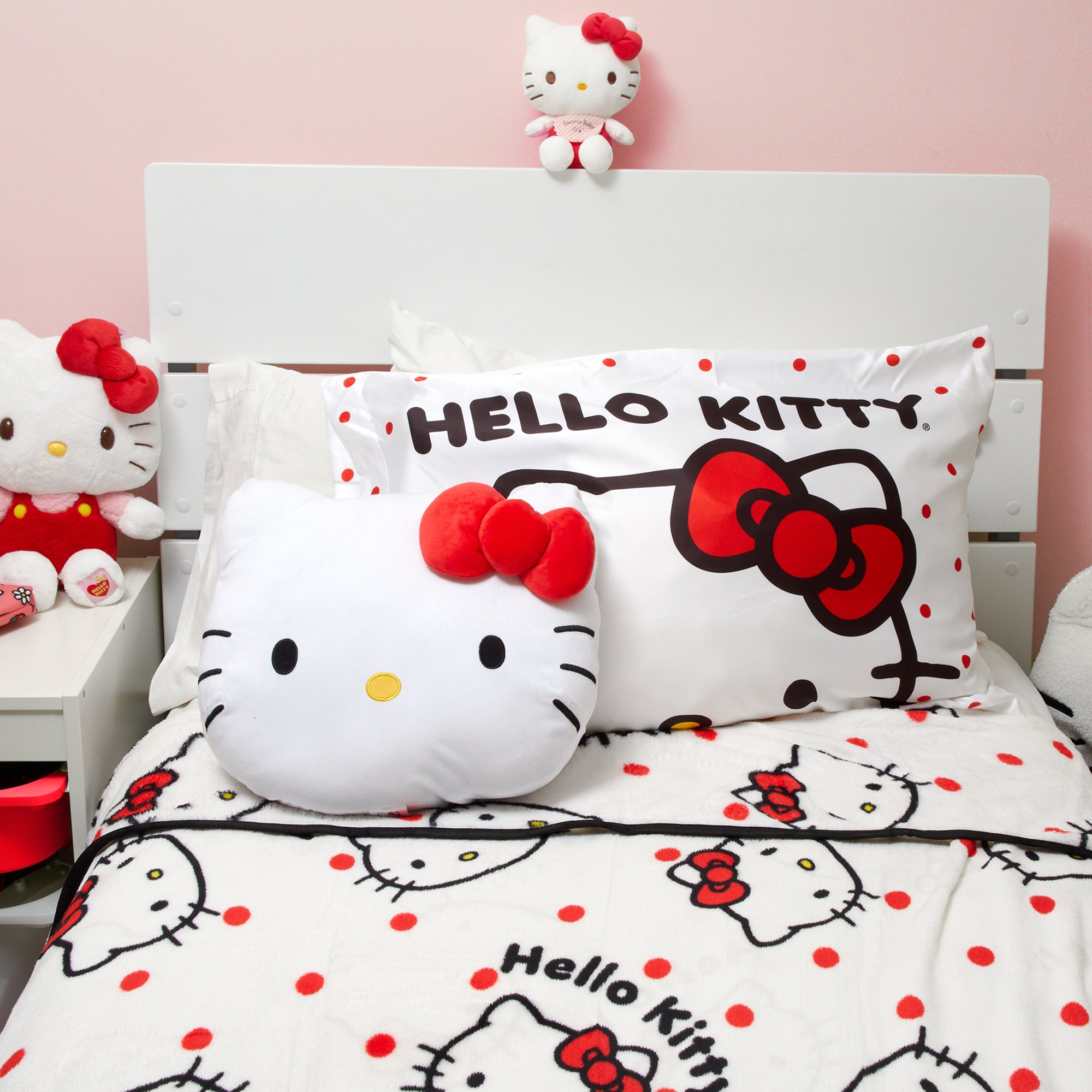Reversible Hello Kitty satin pillowcase being placed on a pillow, demonstrating its standard size fit