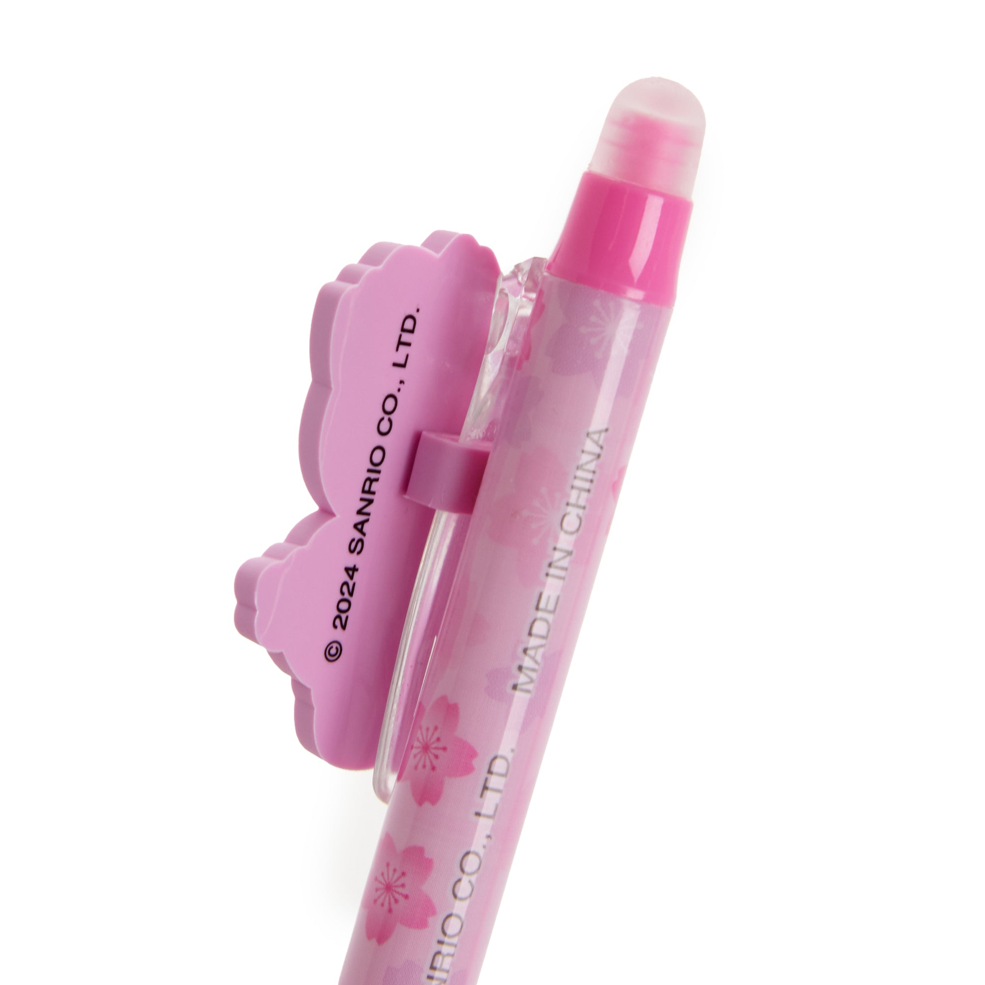Lifestyle shot of a Hello Kitty pen being used in a journal outdoors.