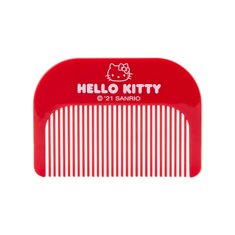 Portable grooming set in use, combing hair with mirror propped up