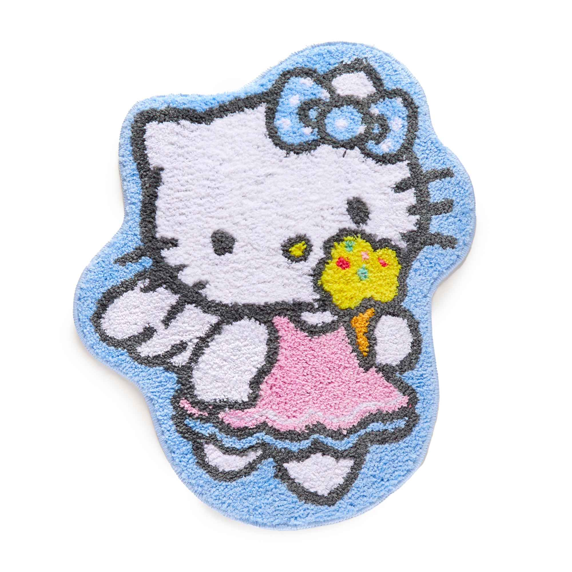 Hello Kitty ice cream rug laid on a wooden floor in a cozy bedroom