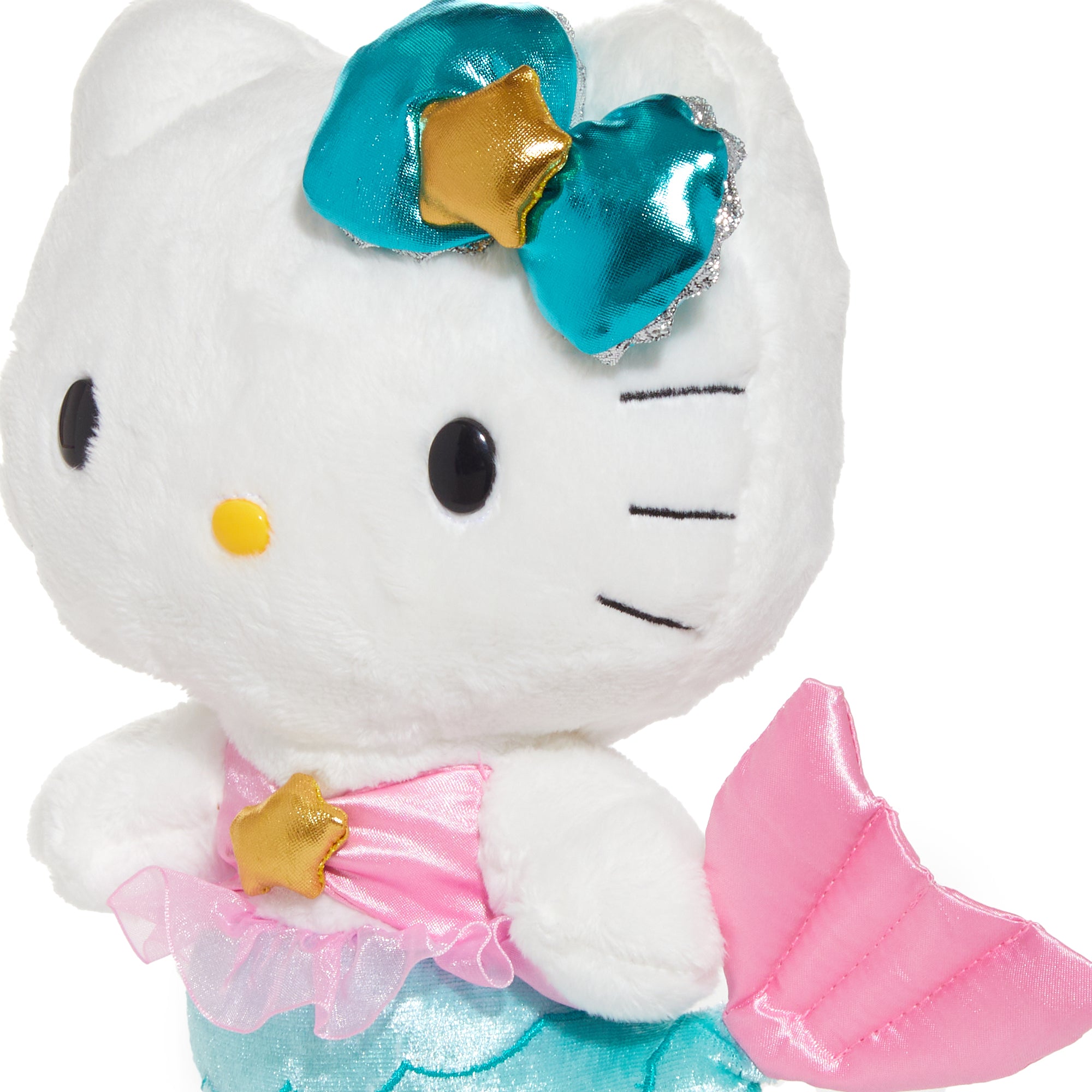 Side view of Hello Kitty zodiac plush sitting on bookshelf in a cozy Missouri bedroom