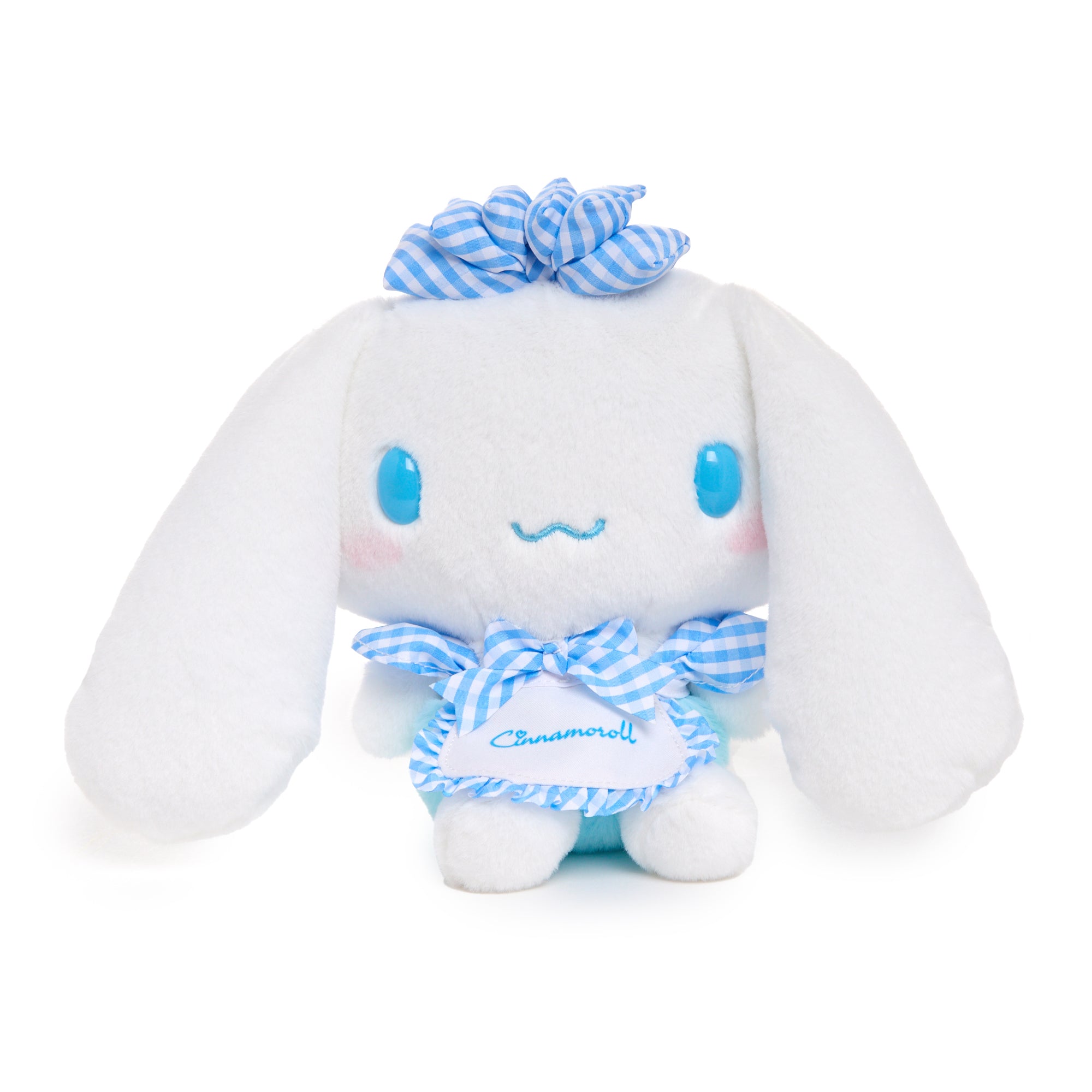 Cinnamoroll plush displayed on a cozy bed, showcasing its soft texture and gingham outfit.