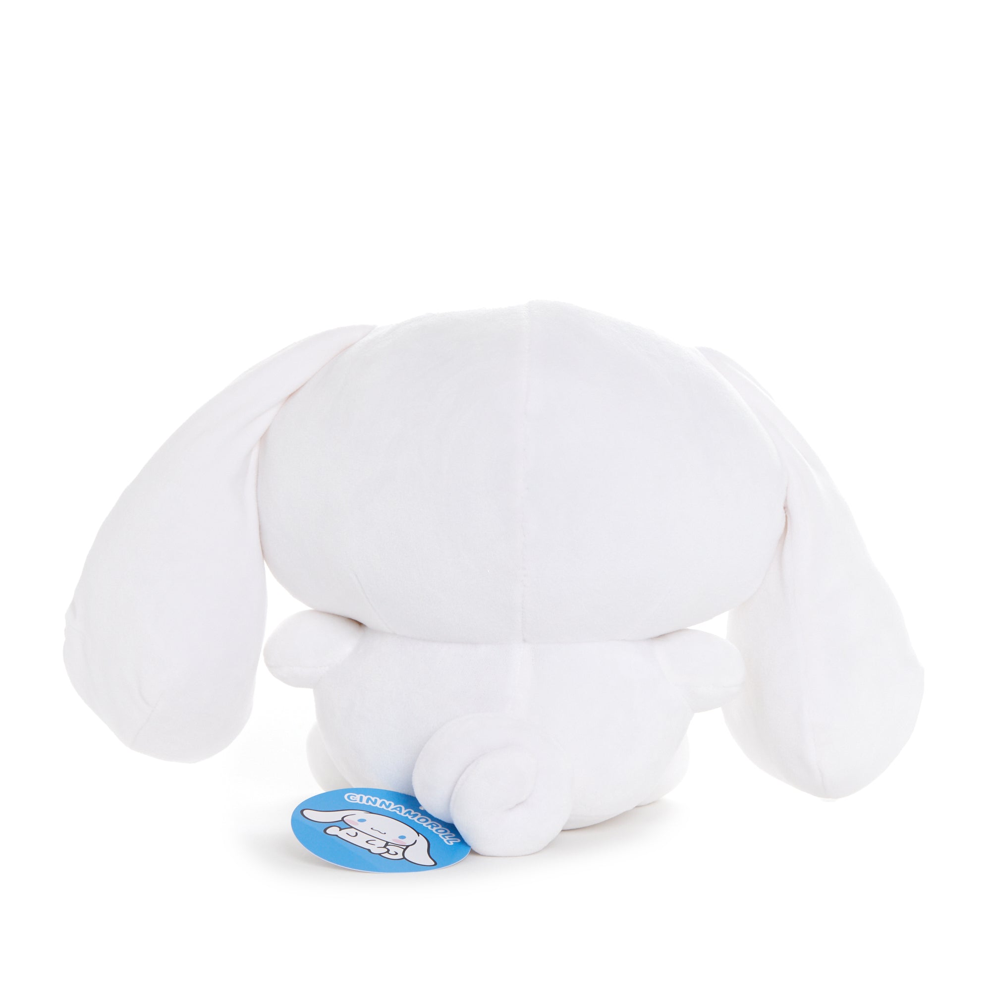 Front view of Cinnamoroll plush toy placed on a bed, ideal for cuddle sessions