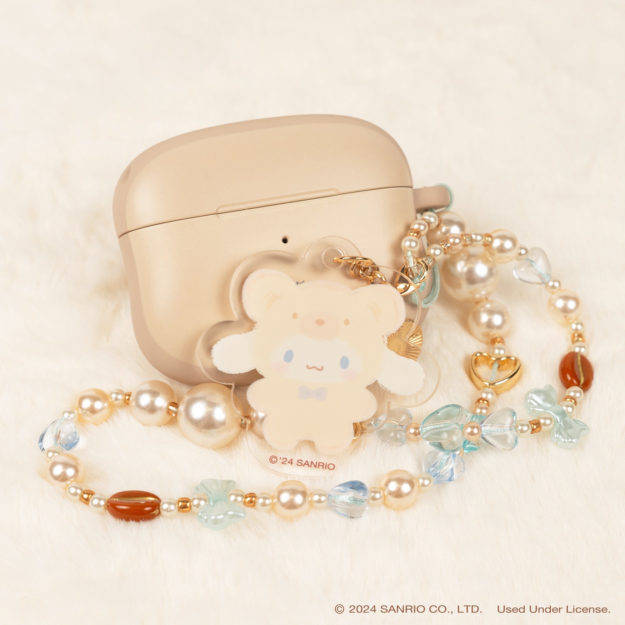 Beaded phone lanyard with character charms attached to a smartphone