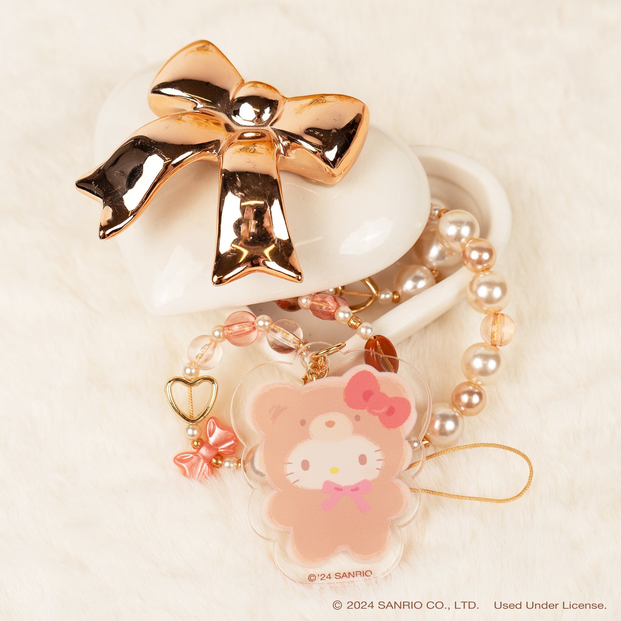 Close-up of Hello Kitty charm on the phone strap, showcasing its playful design.