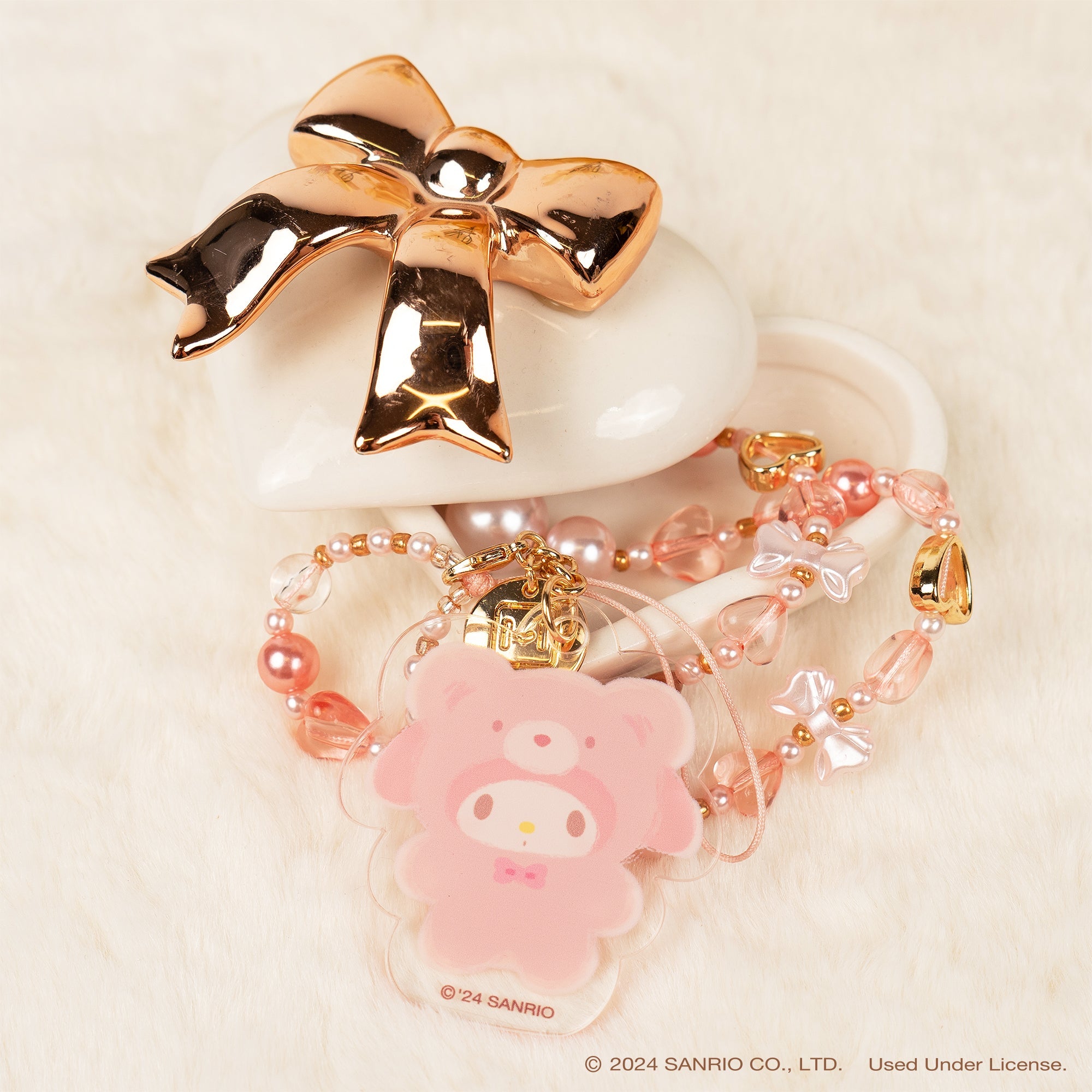 Close-up of Latte Bear beaded charm on a stylish phone strap