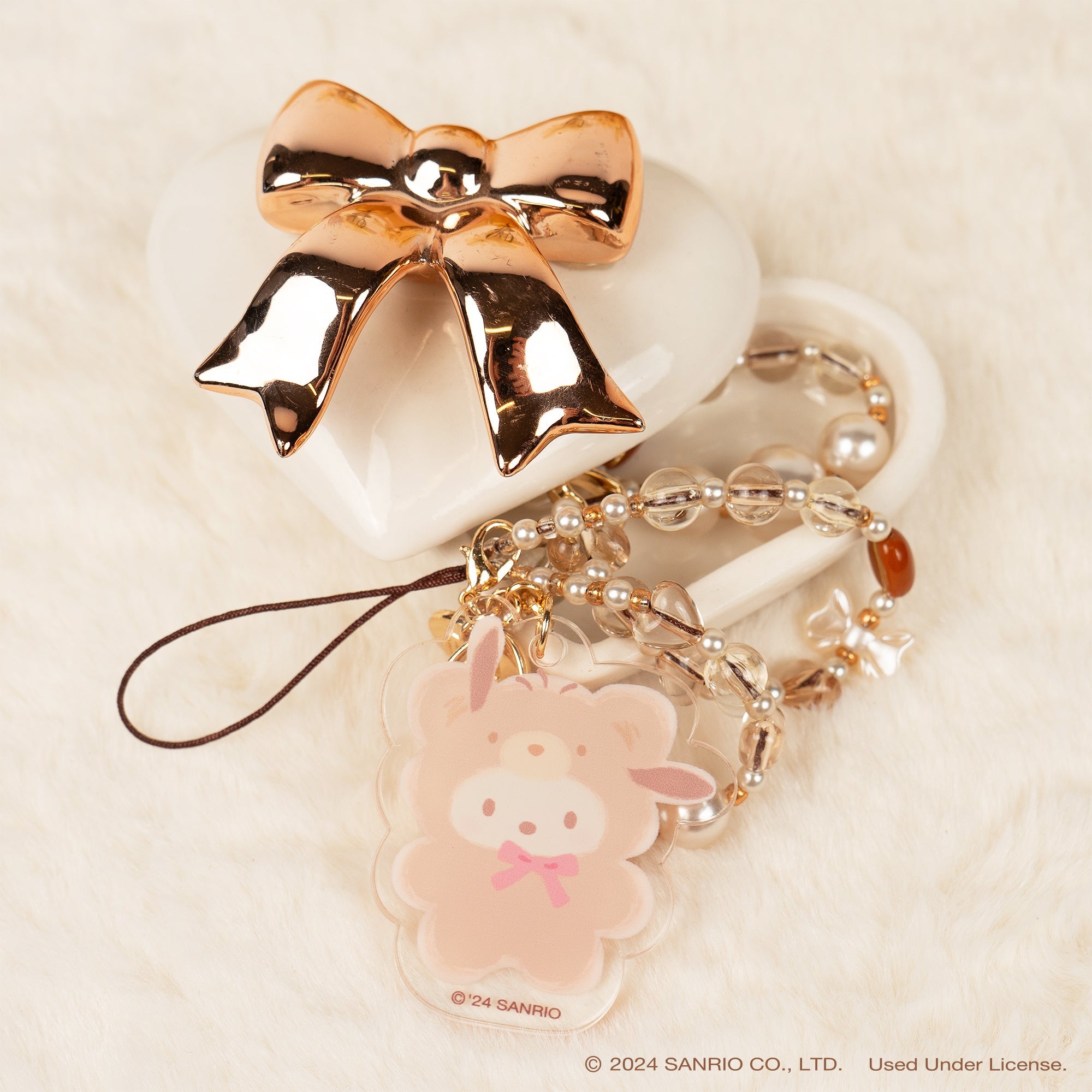 Pochacco Latte Bear beaded phone strap in use at a concert