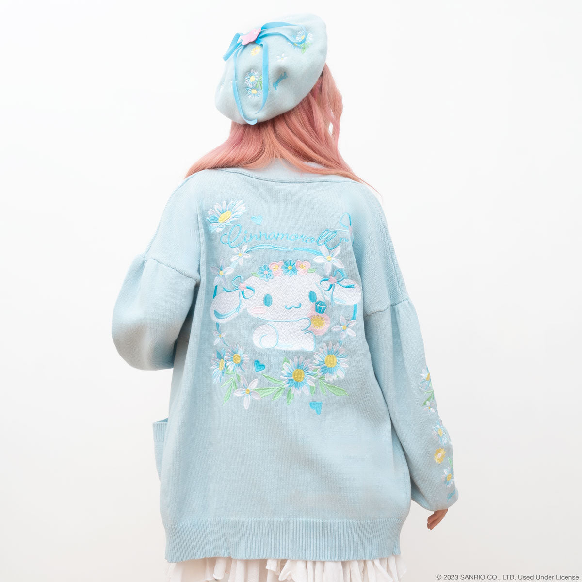 Close-up of the embroidered pockets on the Cinnamoroll floral cardigan showing floral details and soft fabric