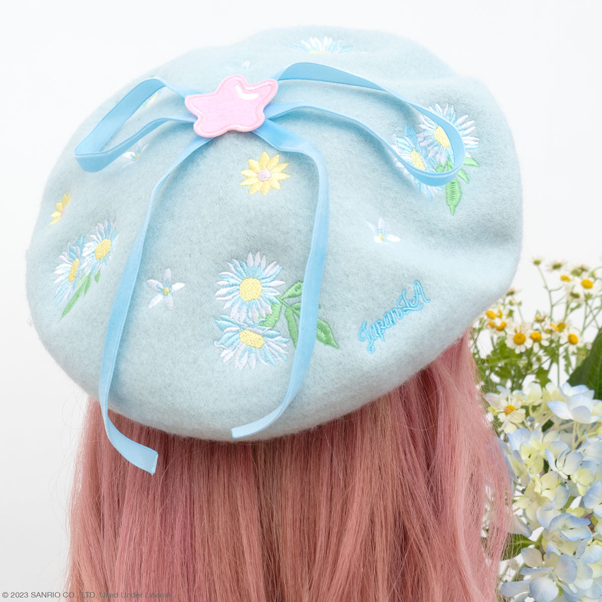 Front view of the Cinnamoroll floral beret with embroidered daisies and ribbons