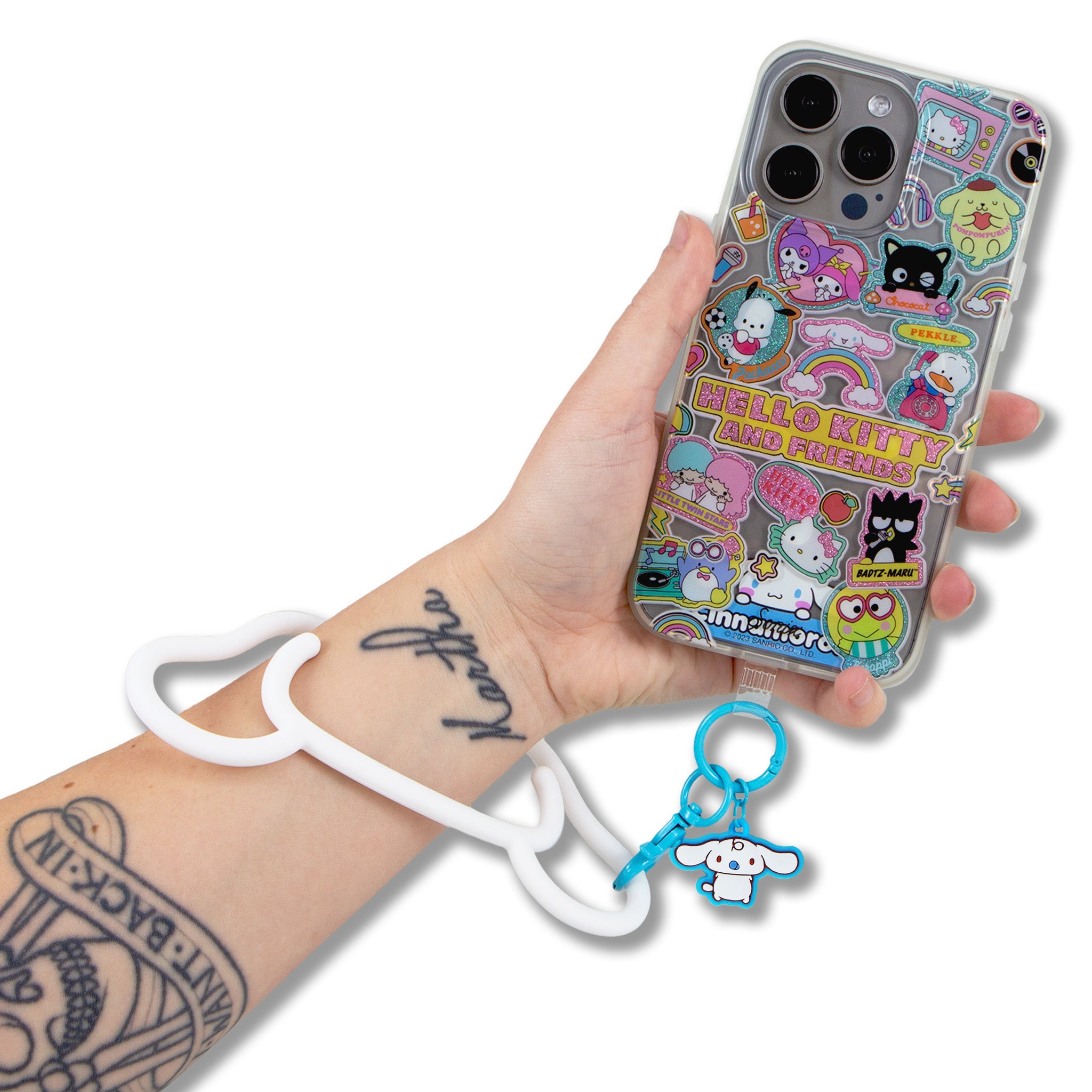 Person wearing a silicone phone bracelet with a Sanrio design while commuting