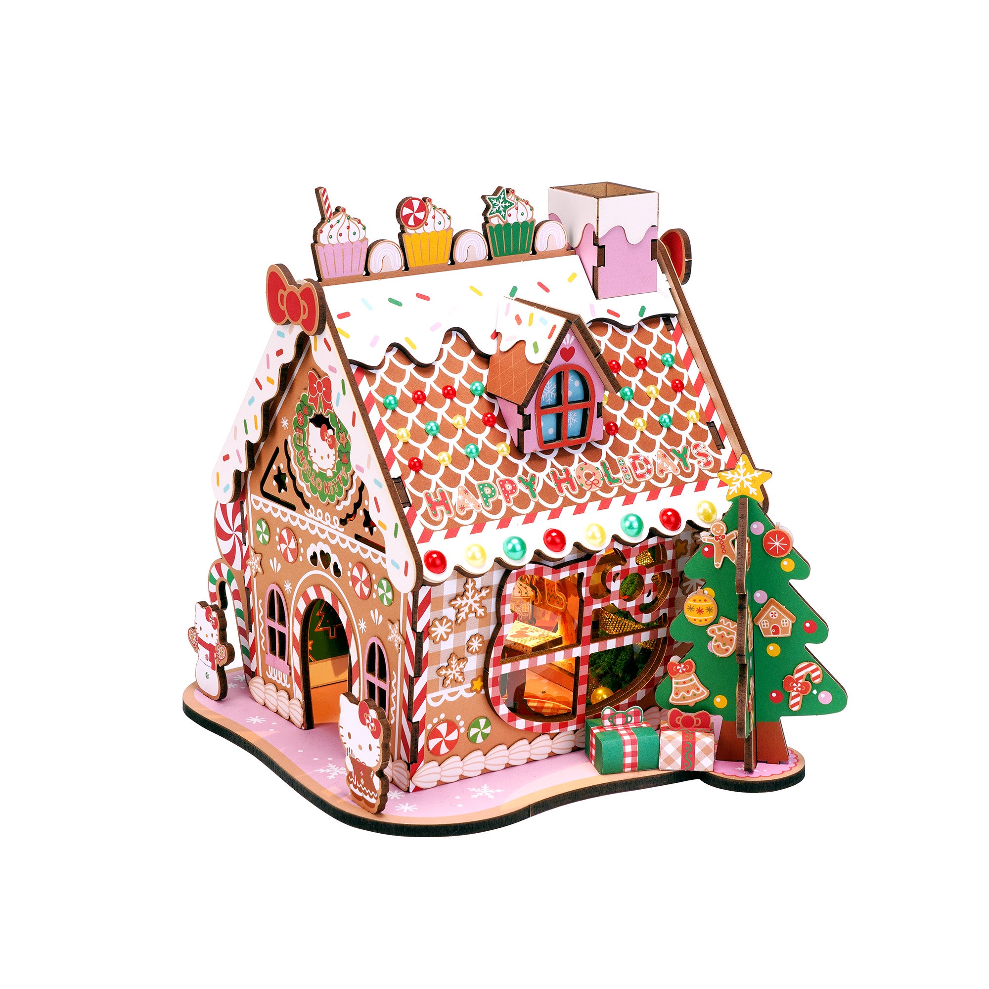 Decorated wooden gingerbread house with Hello Kitty design on a festive table