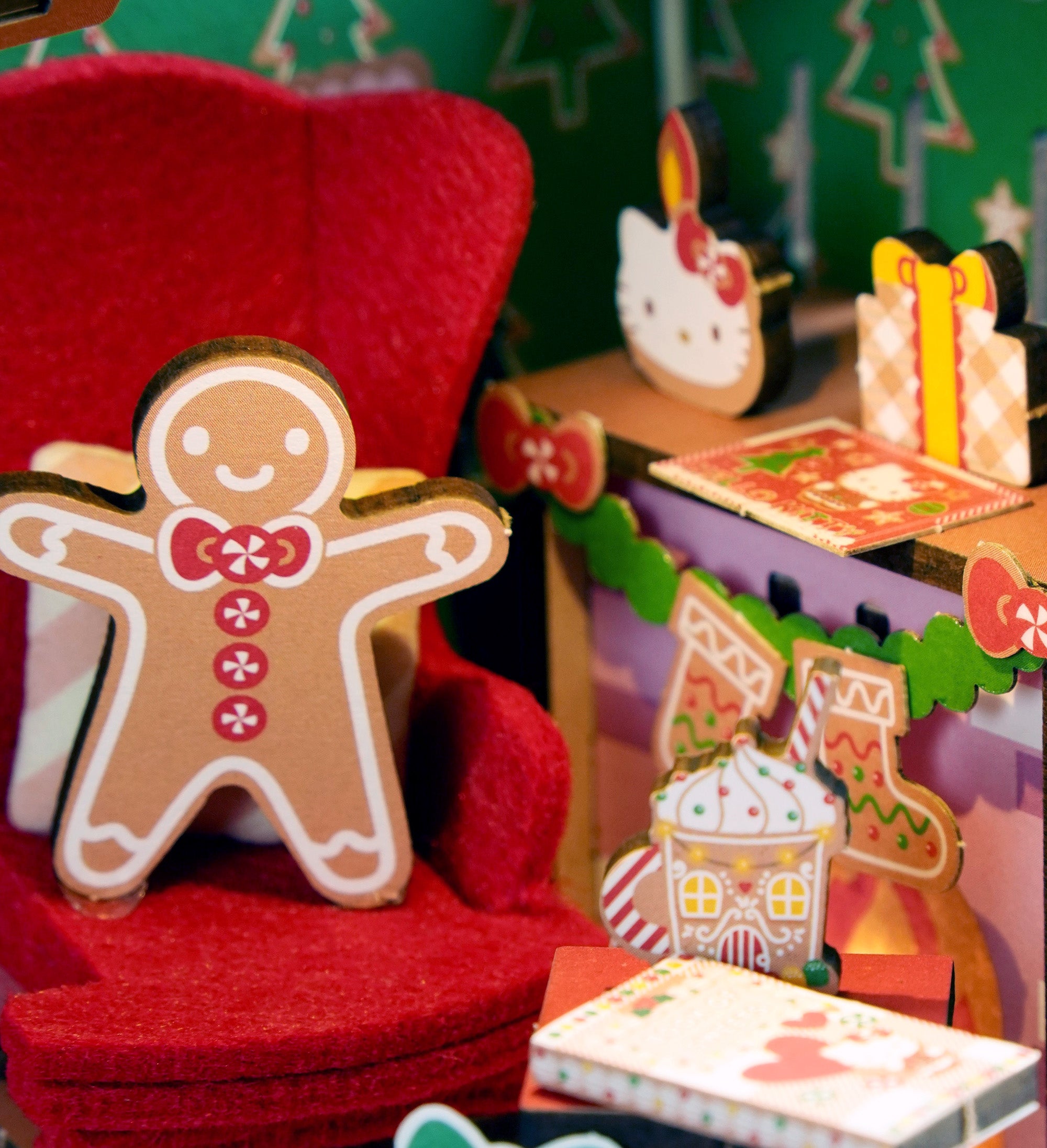 Kids and adults assembling the wooden gingerbread house kit together