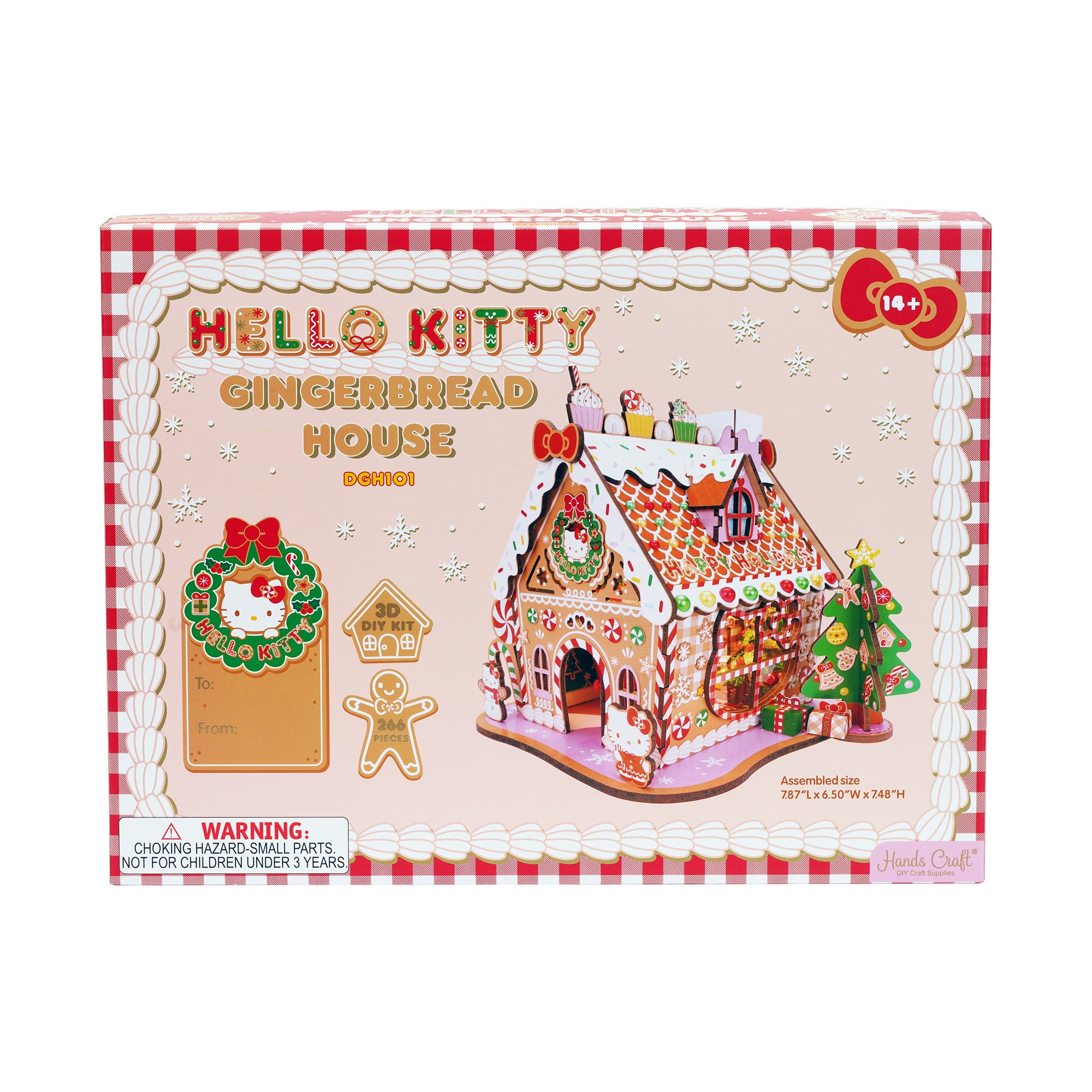 Decorated wooden gingerbread house with Hello Kitty design on a festive table