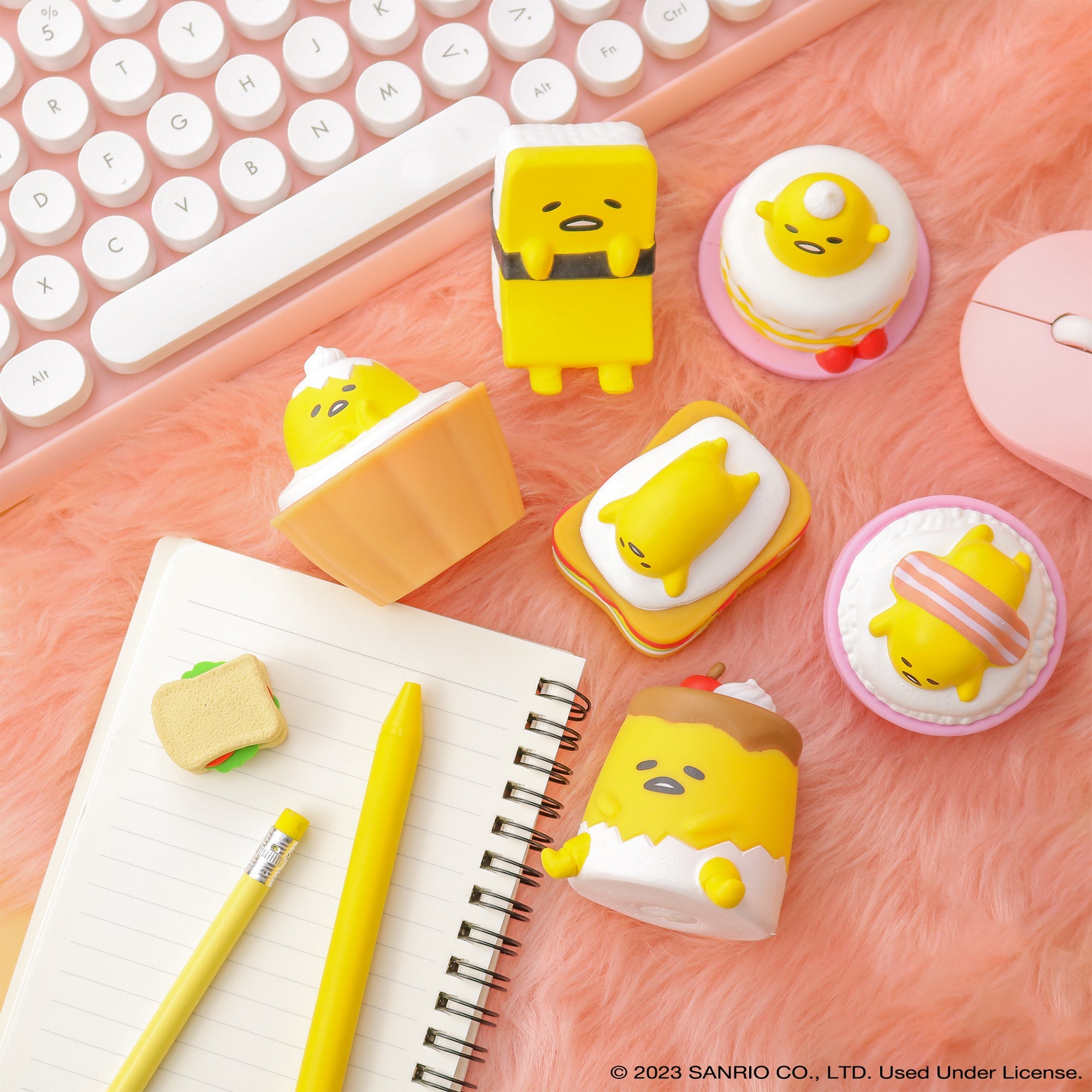 Hand holding one Gudetama squishy near a laptop, perfect desk stress toy