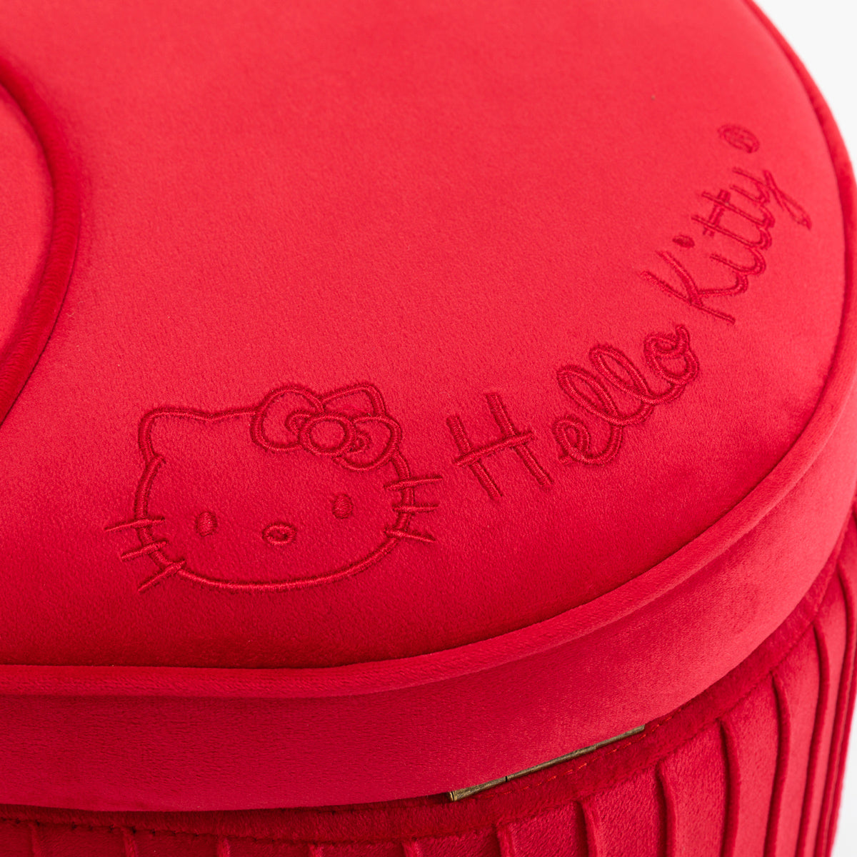 Close-up of pink velvet Hello Kitty storage bench with embroidered bow details