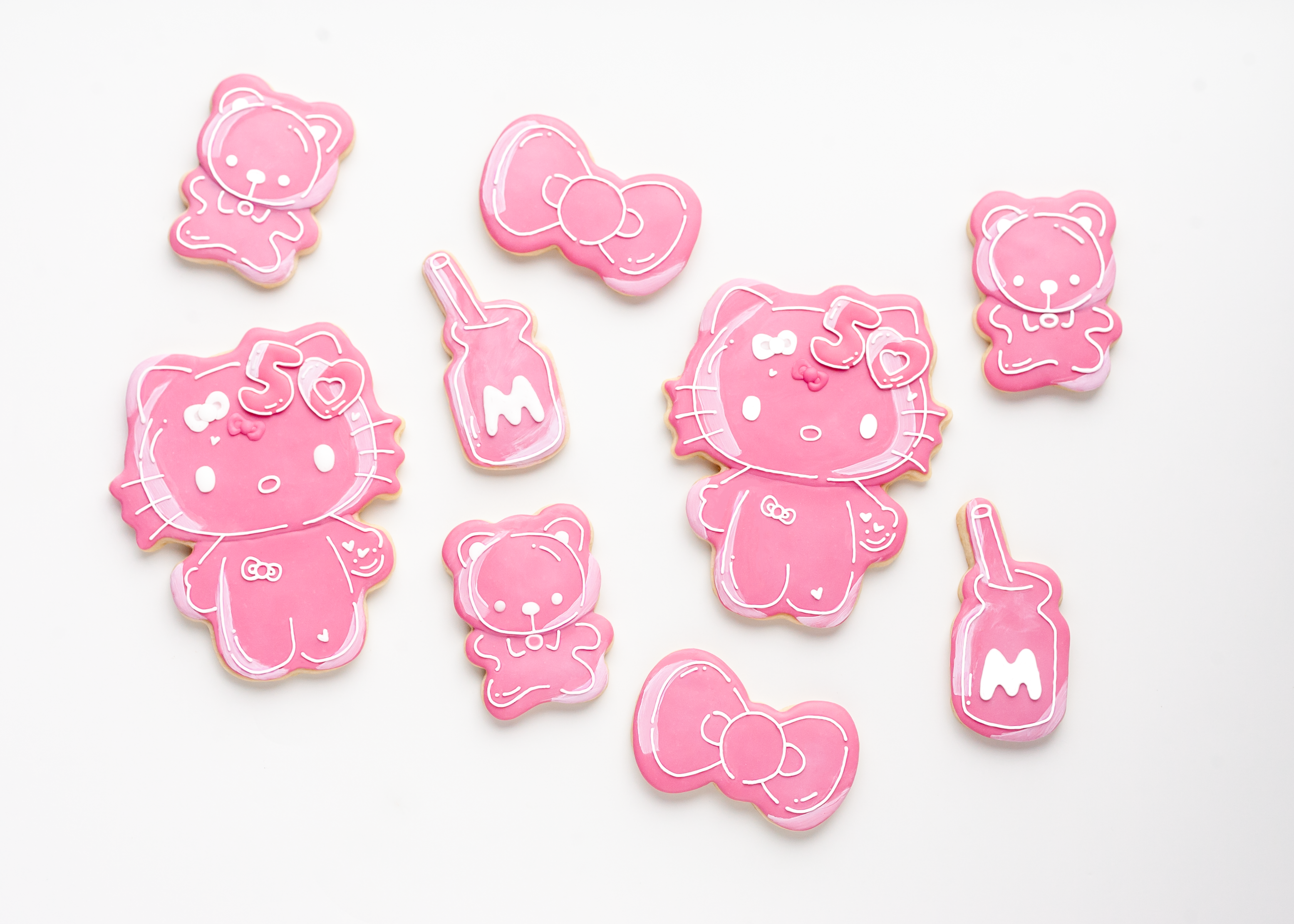 Close-up of Hello Kitty cookie stamp pressed into sugar dough on wood surface