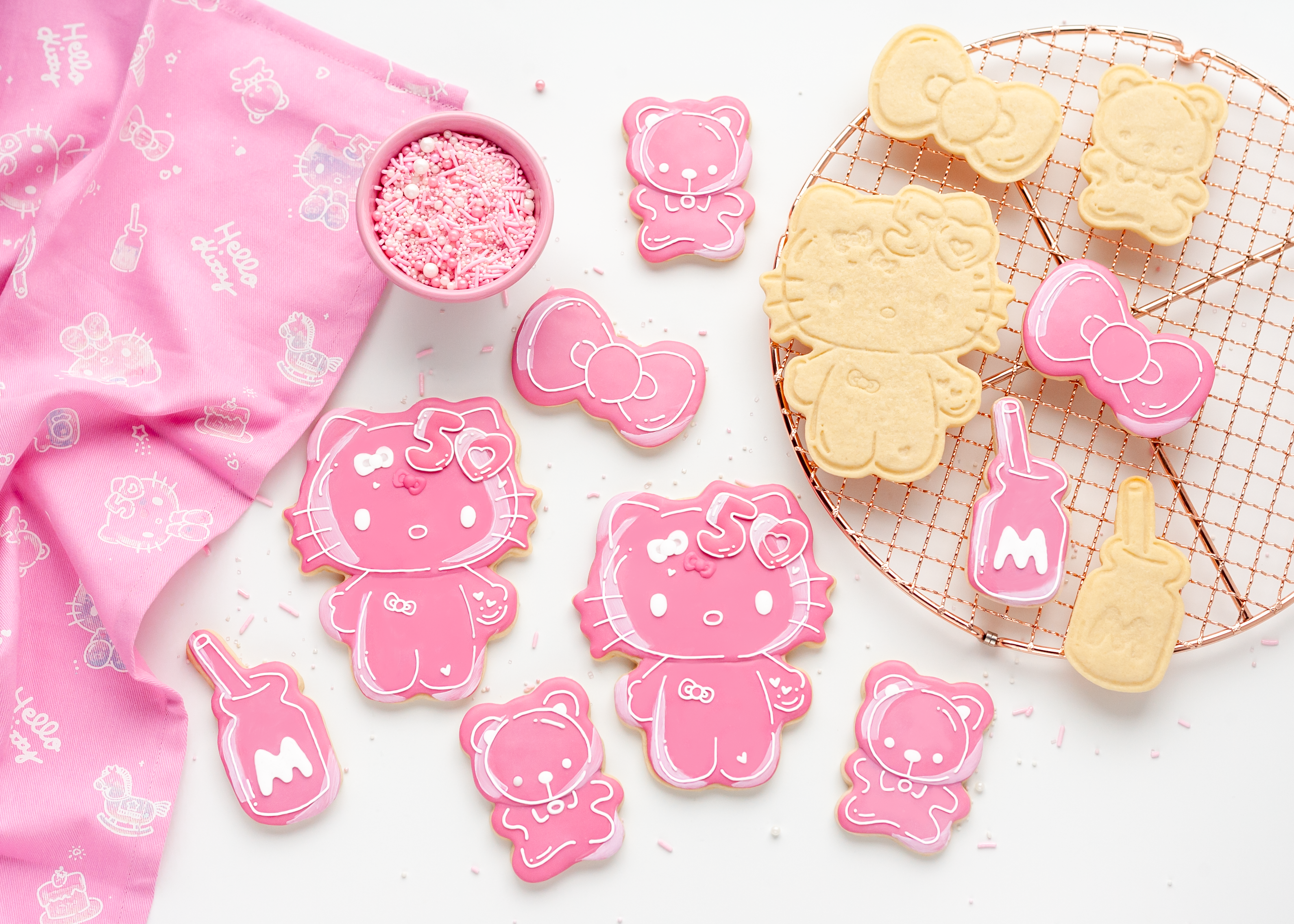 Decorated Hello Kitty cookies using frosting set displayed on ceramic tray