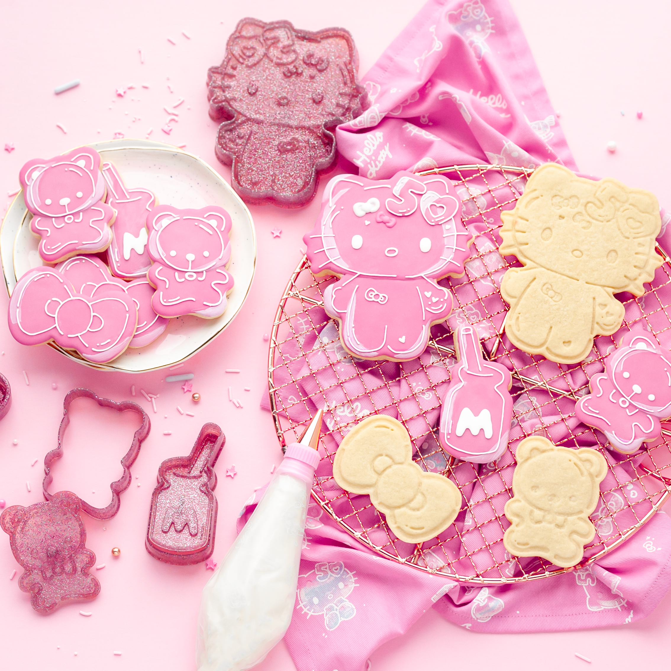 Close-up of Hello Kitty cookie stamp pressed into sugar dough on wood surface