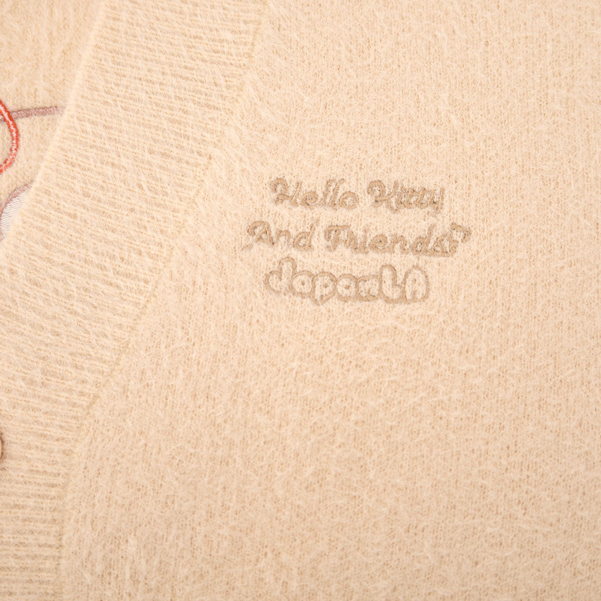 Back view of the Hello Kitty cardigan, highlighting the satin bows on the sleeves