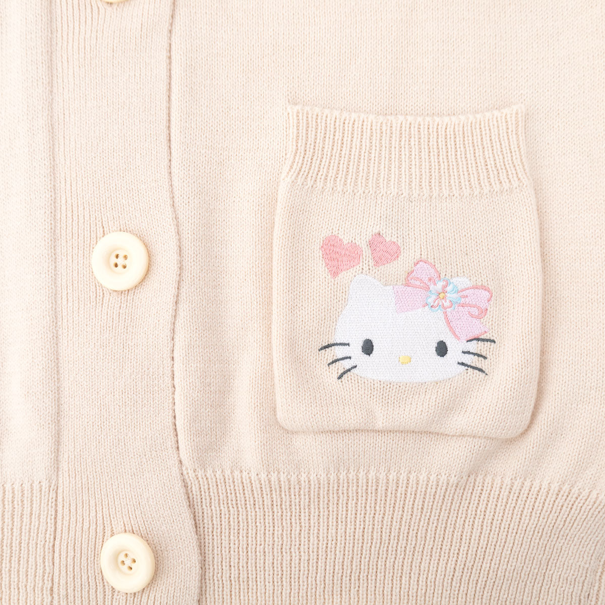 Front view of the Hello Kitty floral cardigan with embroidered pockets