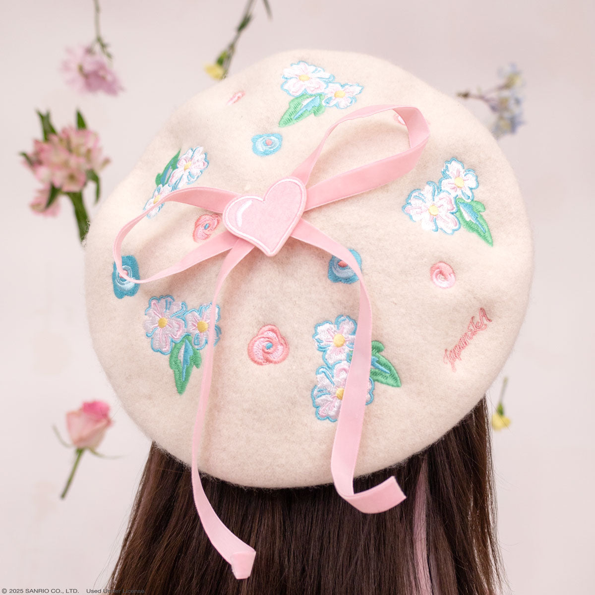 Close-up of Hello Kitty floral beret hat showing embroidered details