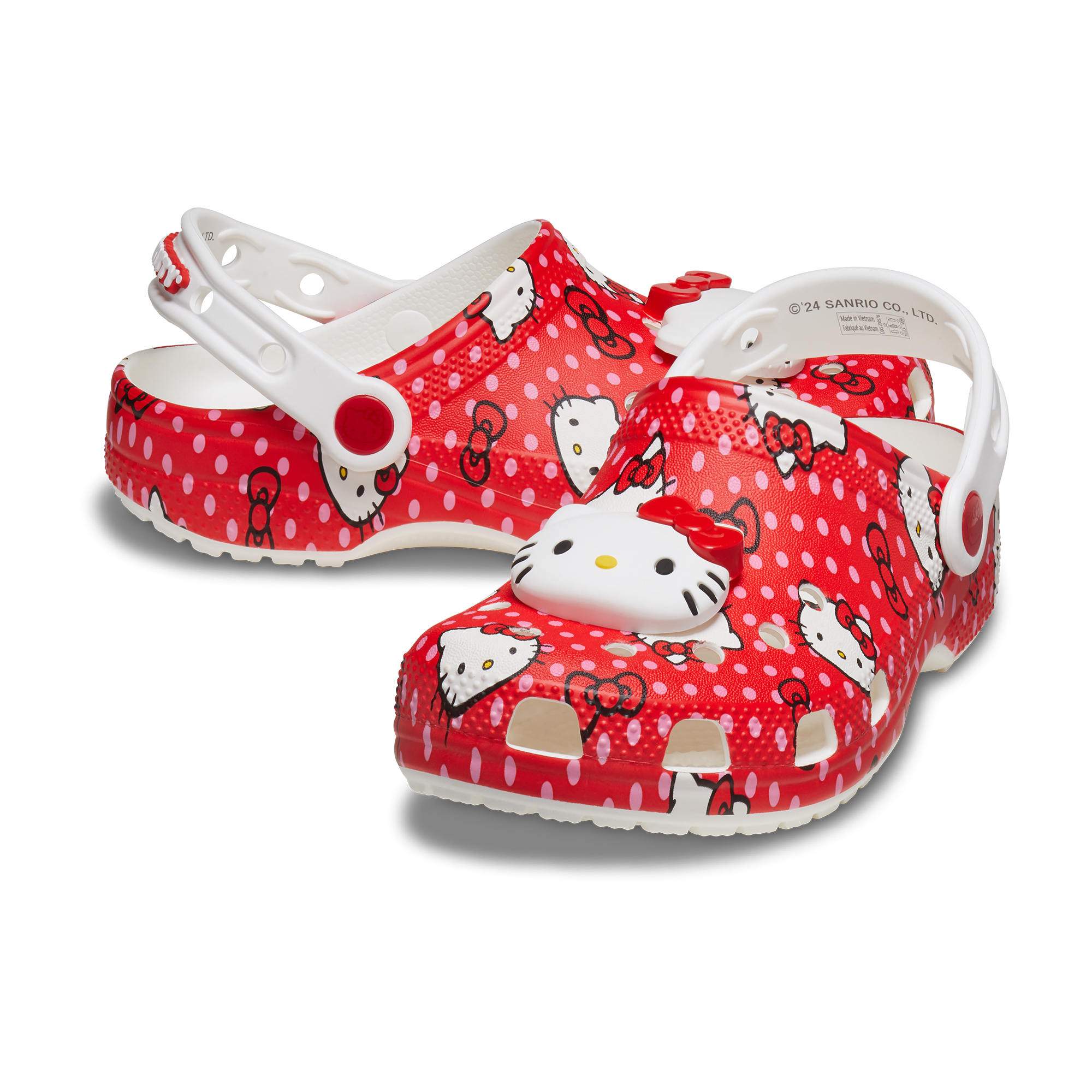 Front view of red Hello Kitty Crocs for kids on a wooden floor