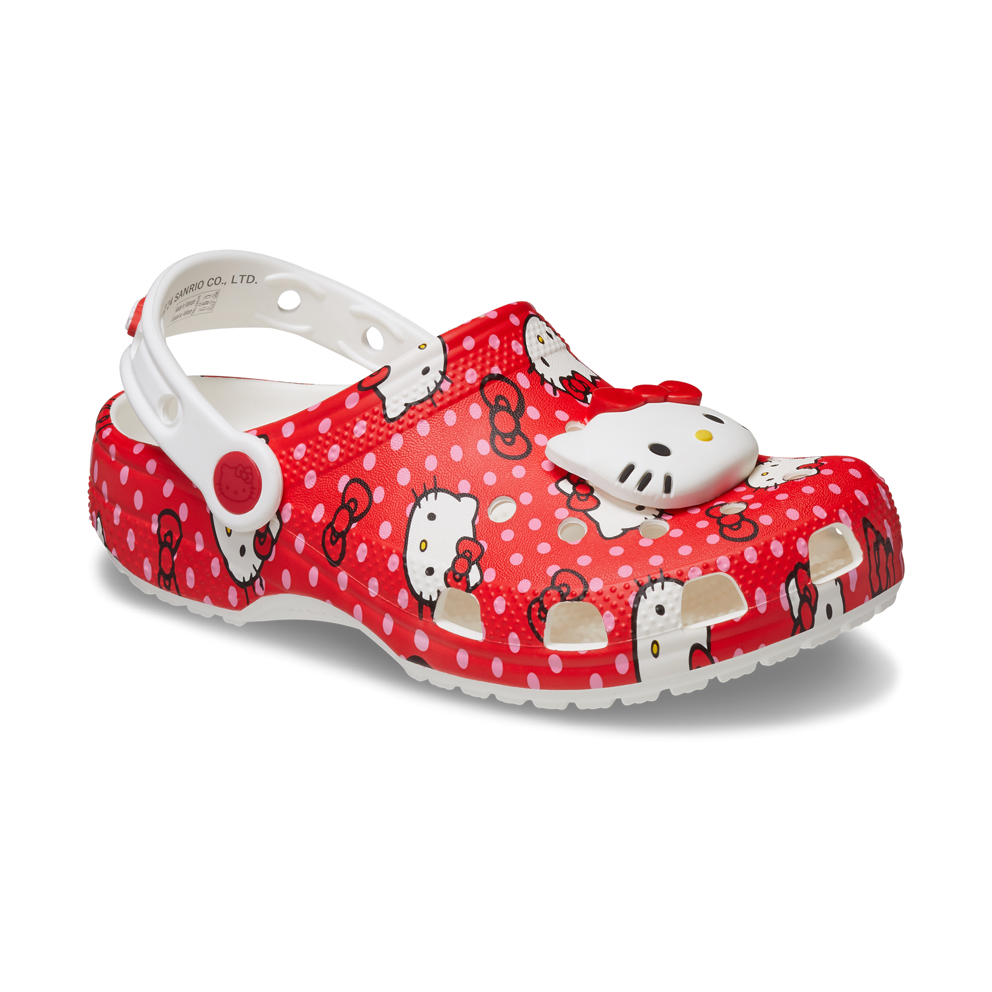 Front view of red Hello Kitty Crocs for kids on a wooden floor