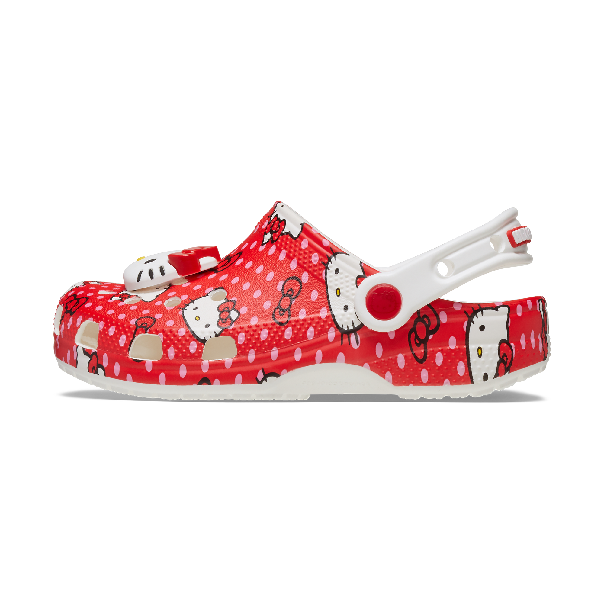 Front view of red Hello Kitty Crocs for kids on a wooden floor