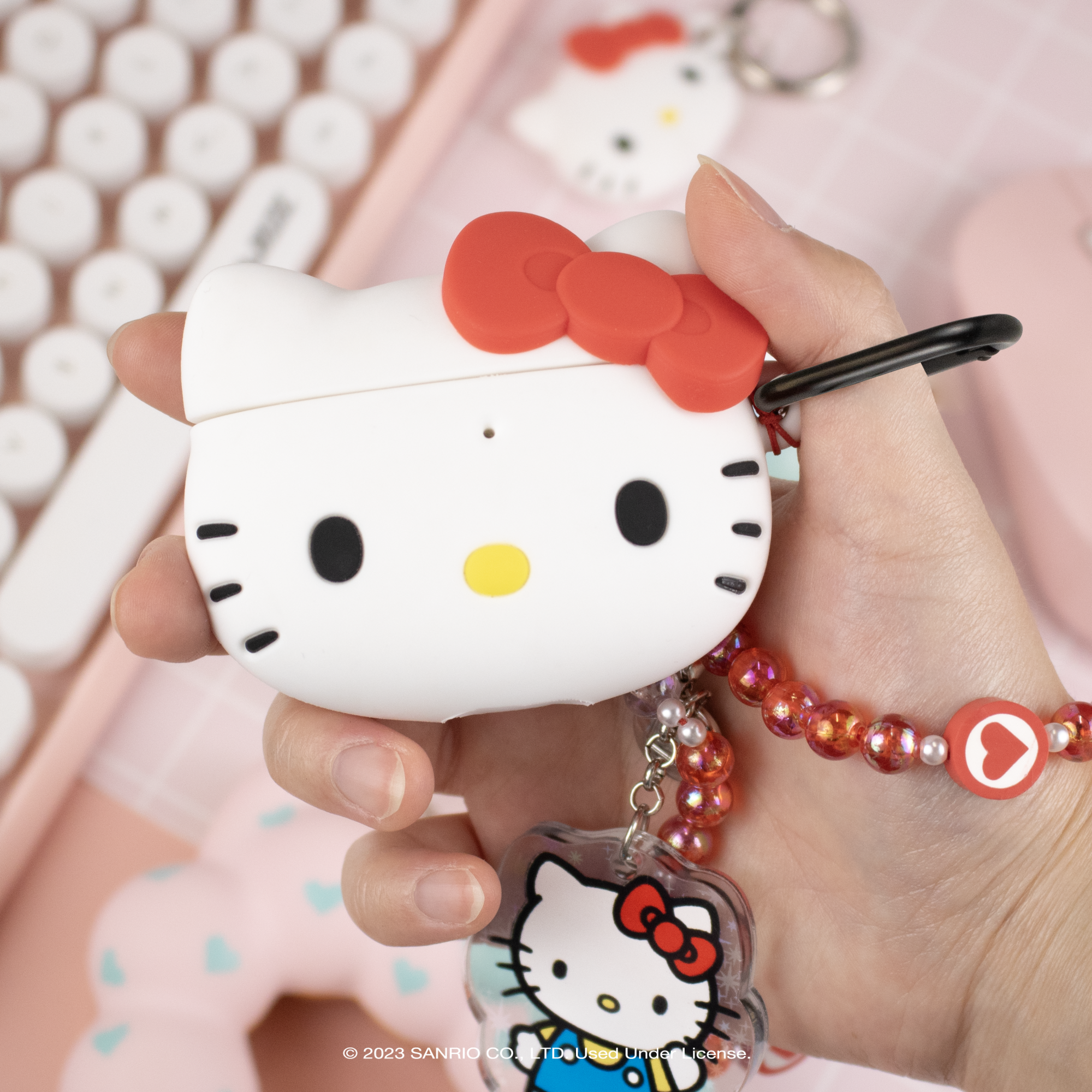 Hello Kitty AirPods case attached to a purse with the carabiner clip