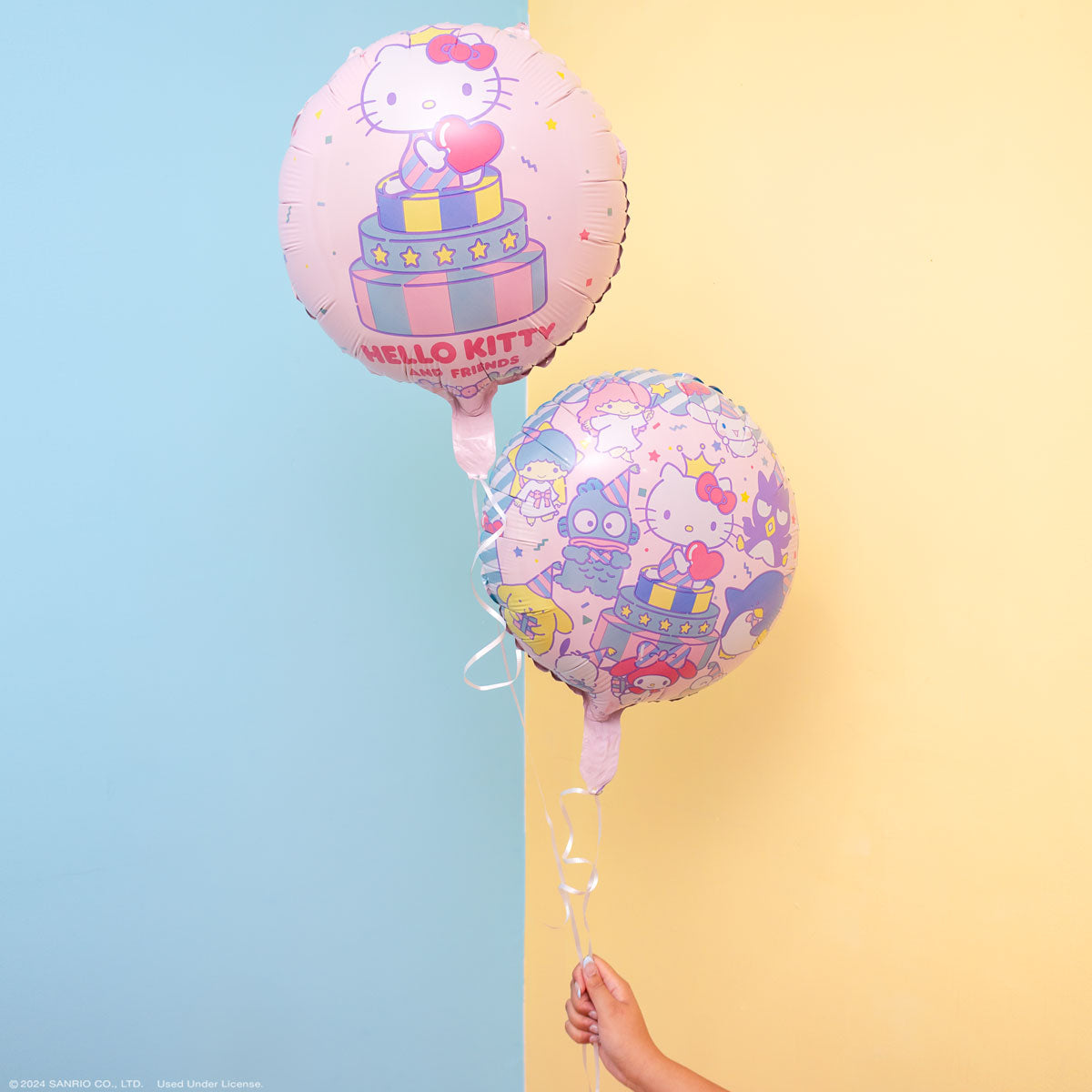 Back side of foil balloon showing alternate character design, placed on table with party balloons