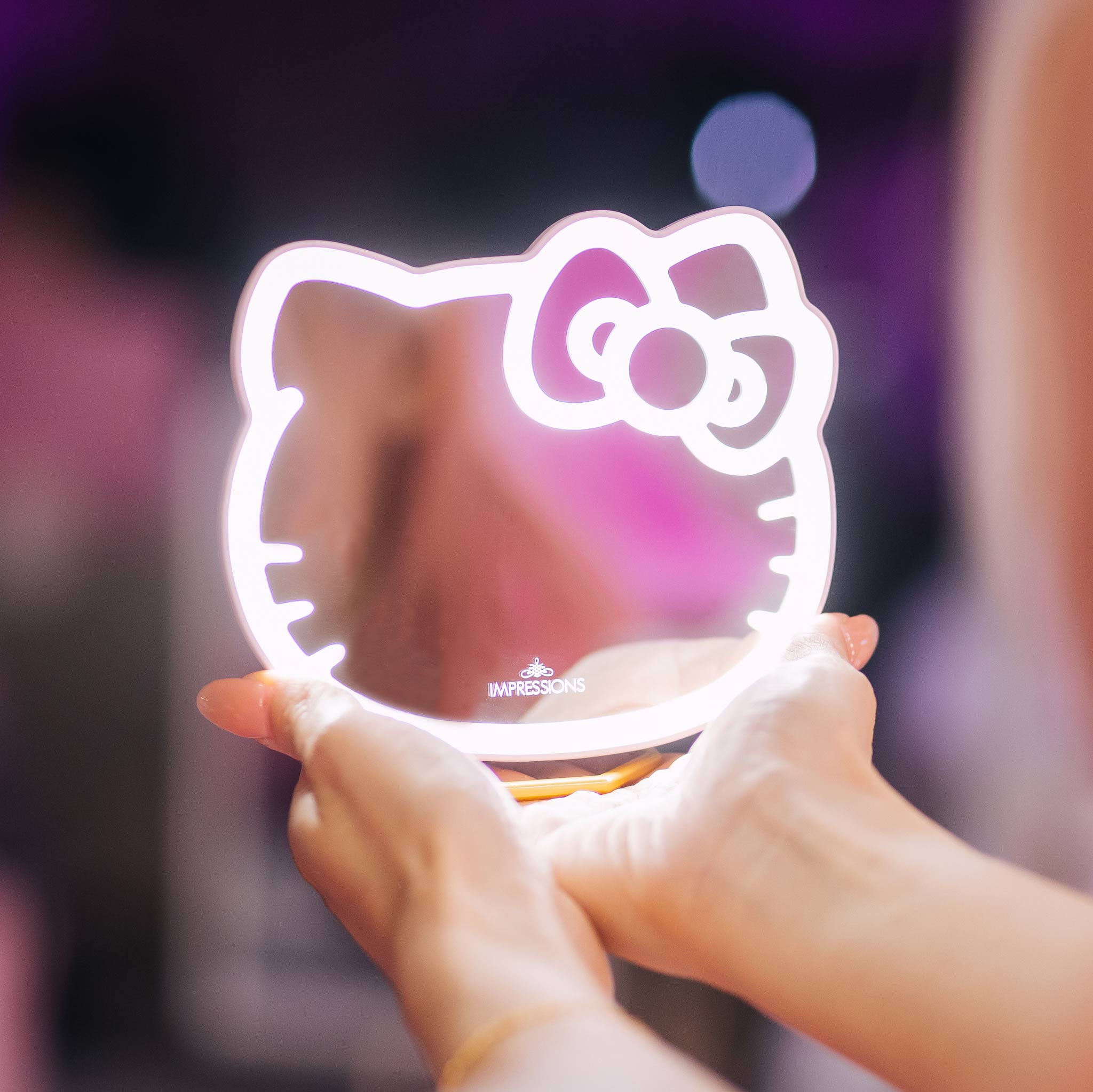 Close-up of Hello Kitty LED mirror showing adjustable brightness settings