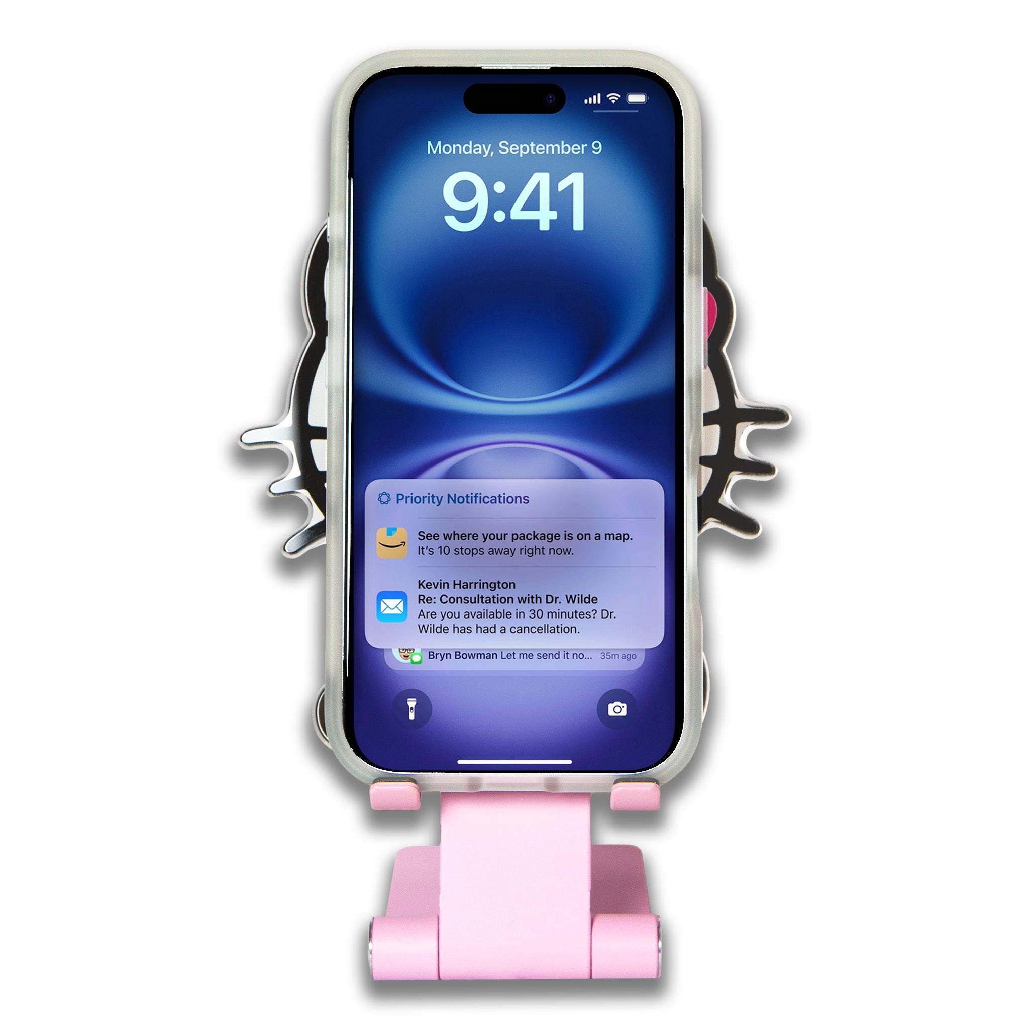 Close-up of Hello Kitty phone stand on a desk, showcasing its design and functionality.