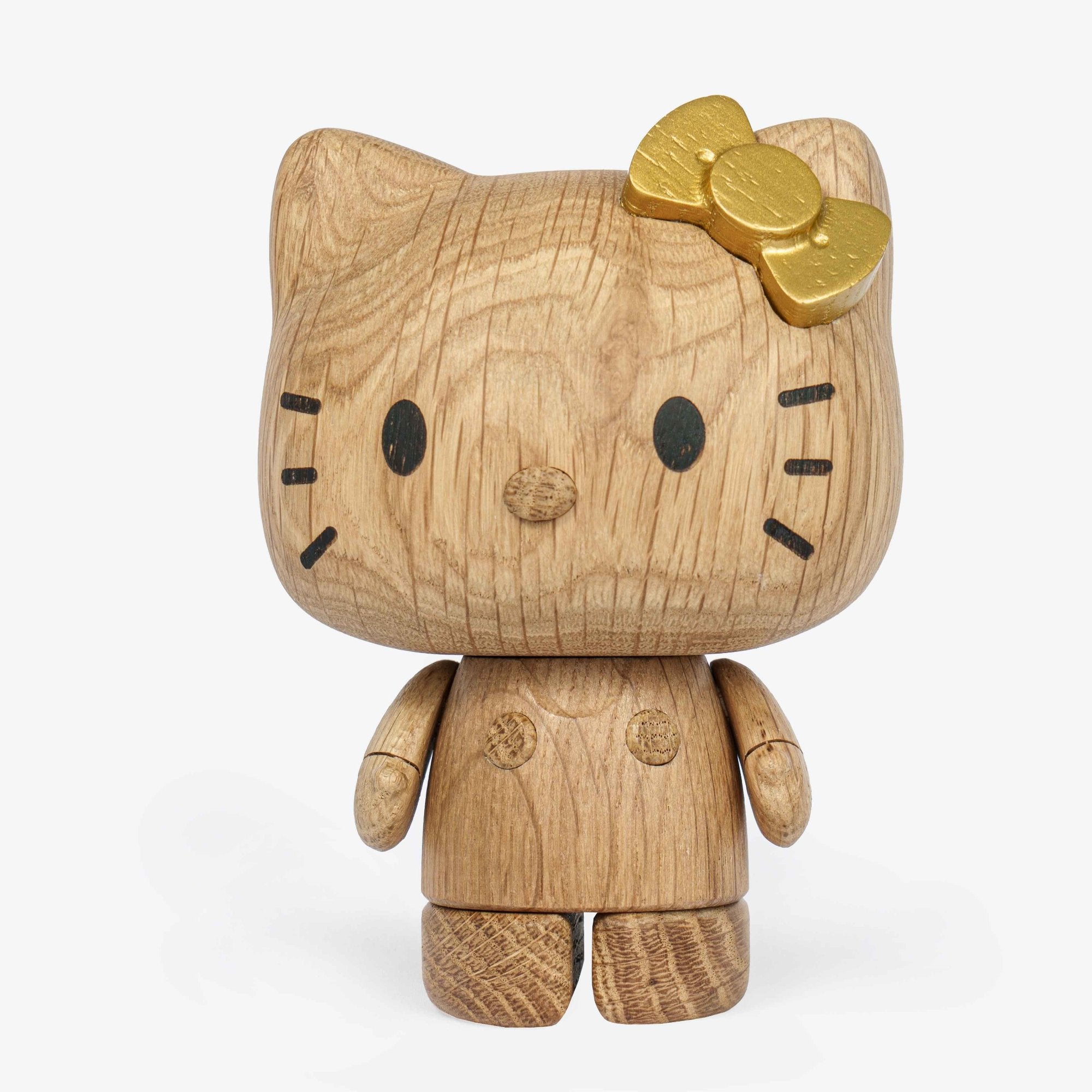Hello Kitty oak figurine close-up with gold bow detailing