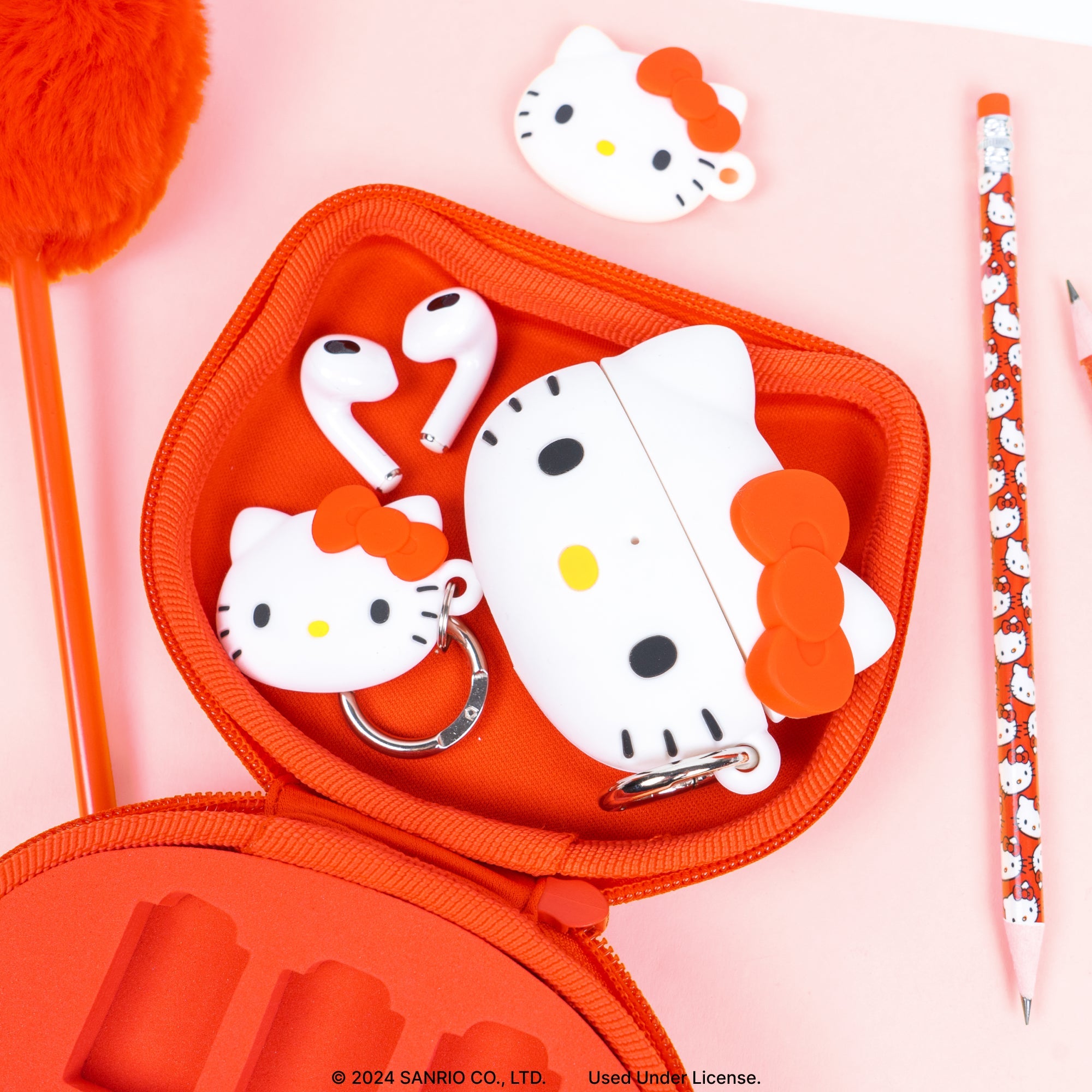 Hello Kitty case attached to a backpack with carabiner.