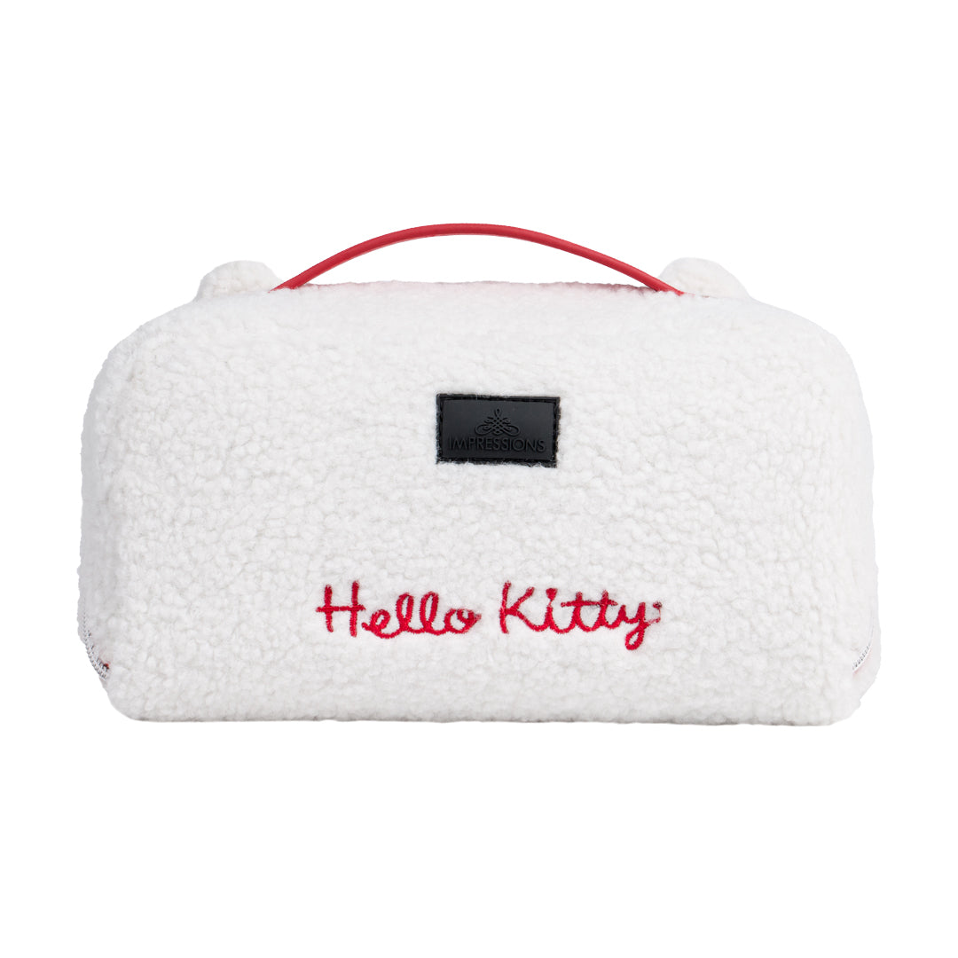 Open travel makeup bag showing inner pockets and polka-dot lining