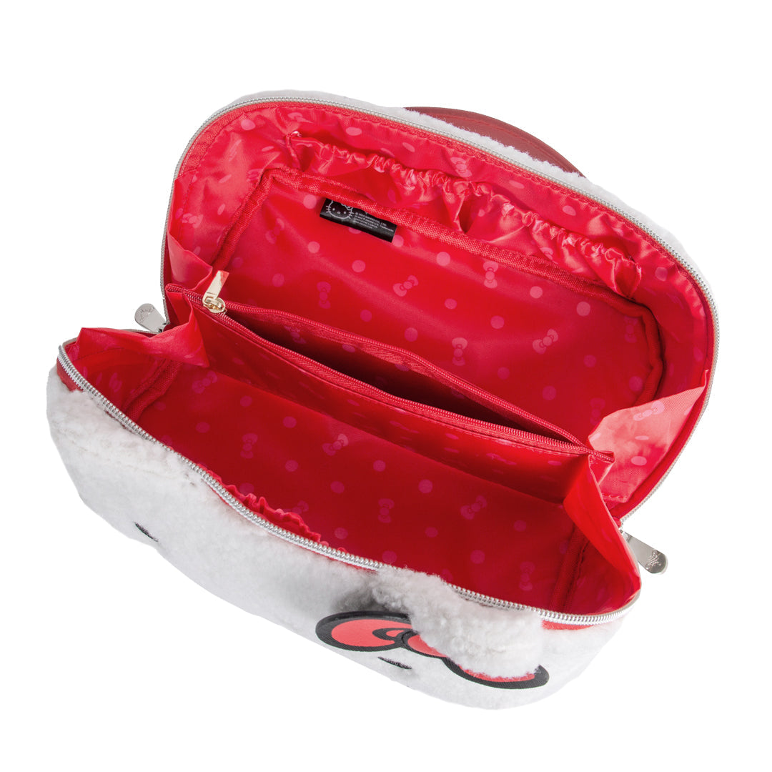 Open travel makeup bag showing inner pockets and polka-dot lining